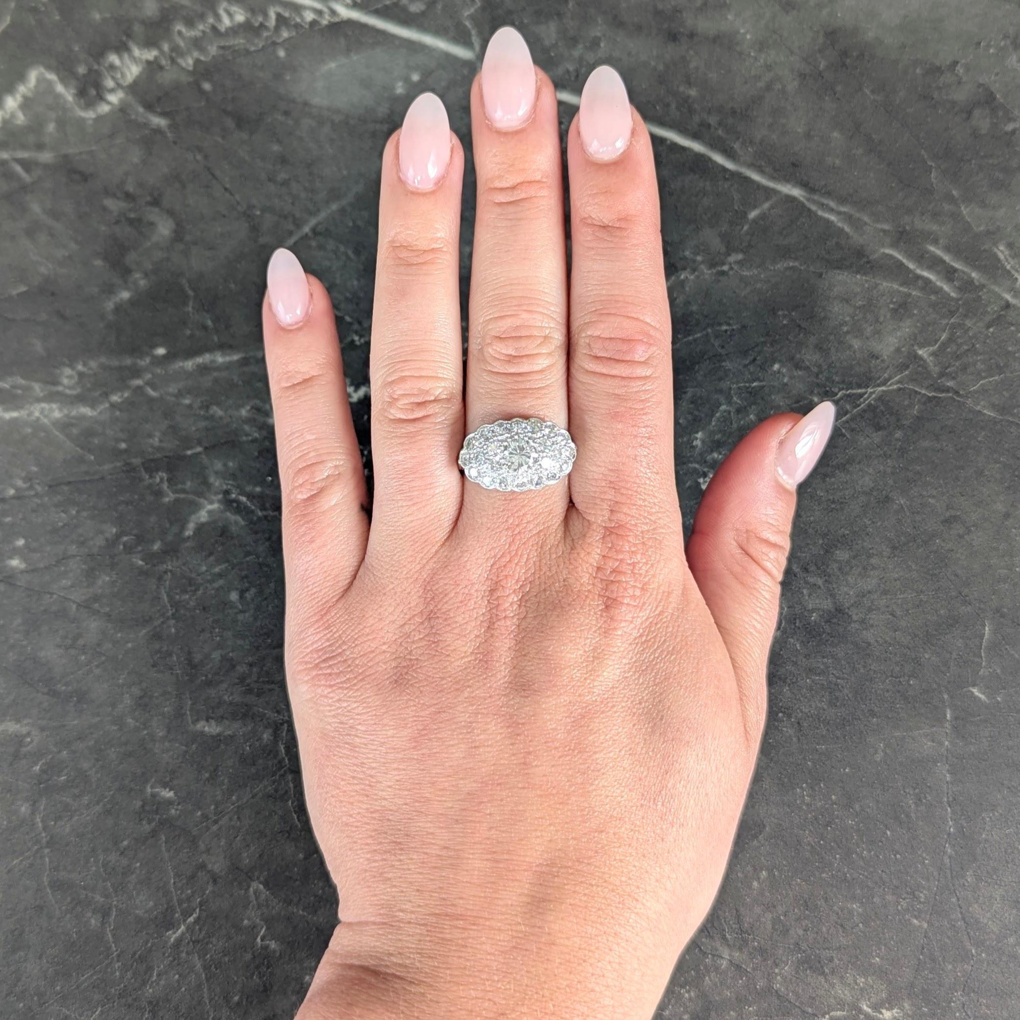 Designed as a scalloped oval shaped form centering an old European cut diamond
Weighing approximately 0.80 carat total - H color with VS2 clarity
Bead set throughout with additional old European cut diamonds
Weighing approximately 1.32 carats total