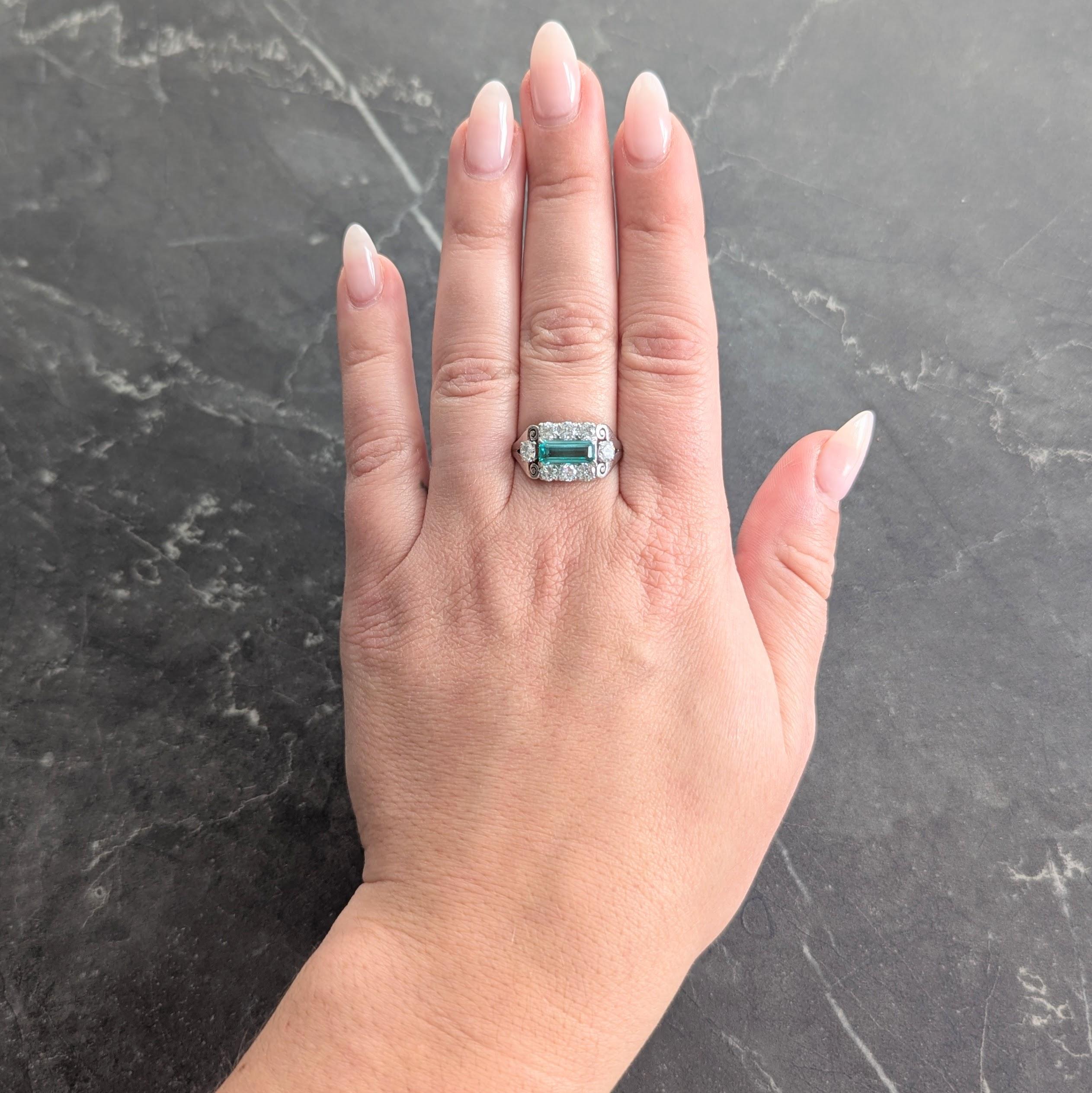 Au centre, une émeraude allongée de taille émeraude pesant environ 1,14 carats - vert moyen transparent
Serti d'est en ouest avec un halo entouré de diamants de taille transitionnelle sertis d'est en ouest.
Poids total d'environ 1,00 carat - Couleur