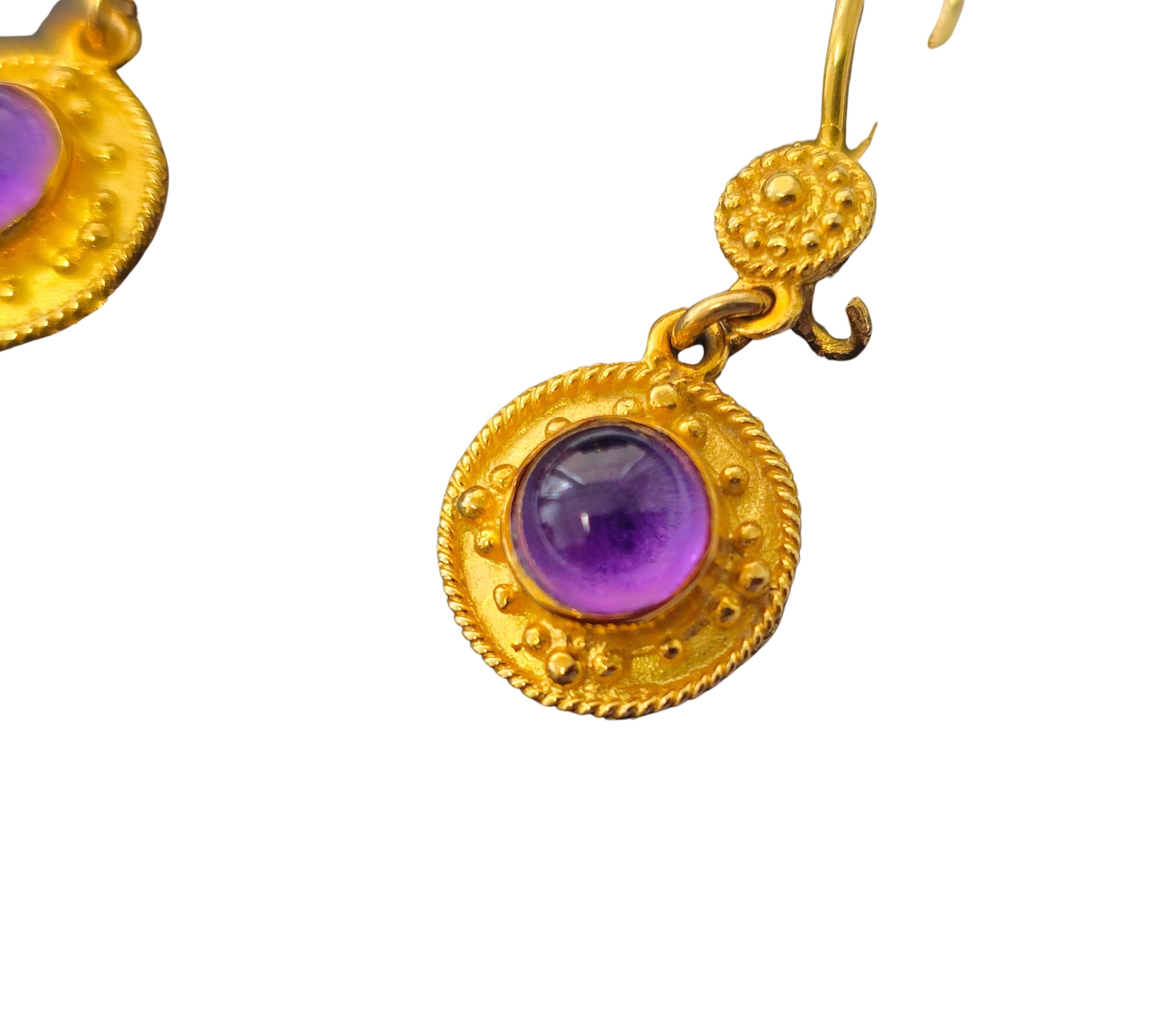 Made from luxurious 18k yellow gold, these mid-century earrings feature mesmerizing amethyst gemstones with a total weight of 2.24 carats, each exhibiting deep saturation and natural earth-mined beauty. The cabochon cut enhances the richness of the