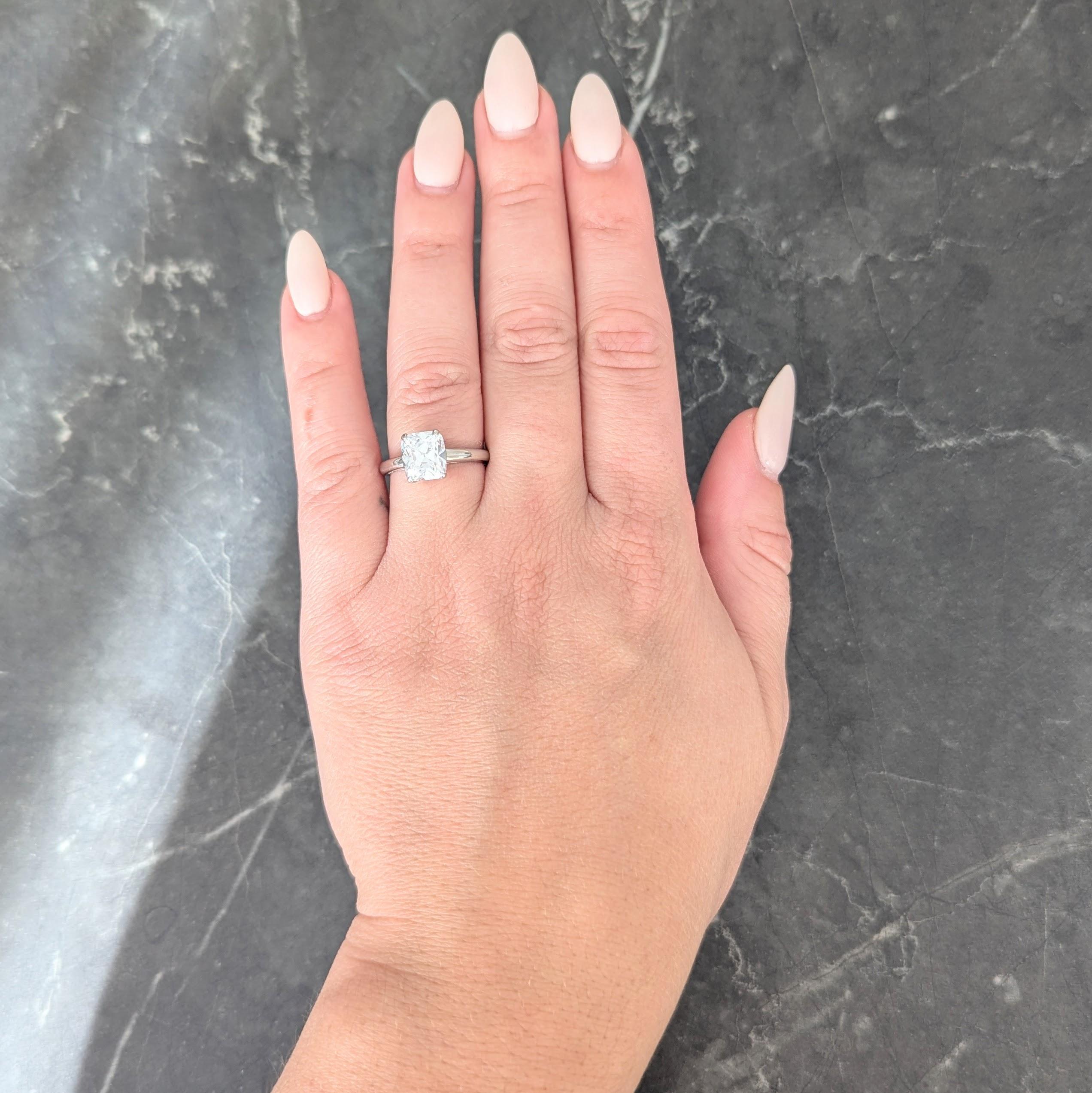 Centering an carat old mine cushion cut diamond weighing 2.33 carats -F in color with SI1 clarity
Set in basket via talon style prongs
Flanked by cathedral shoulders
Tested with partial stamp for platinum
Circa: 1950s
Ring size: 6 and