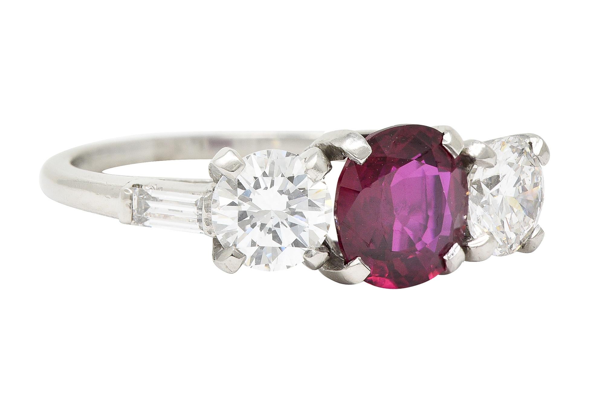 Centering a cushion cut ruby weighing 1.56 carats total - transparent vibrant red in color
Natural Thai in origin with no indications of heat treatment - prong set in basket
Flanked by two round brilliant cut diamonds prong set in baskets
Weighing