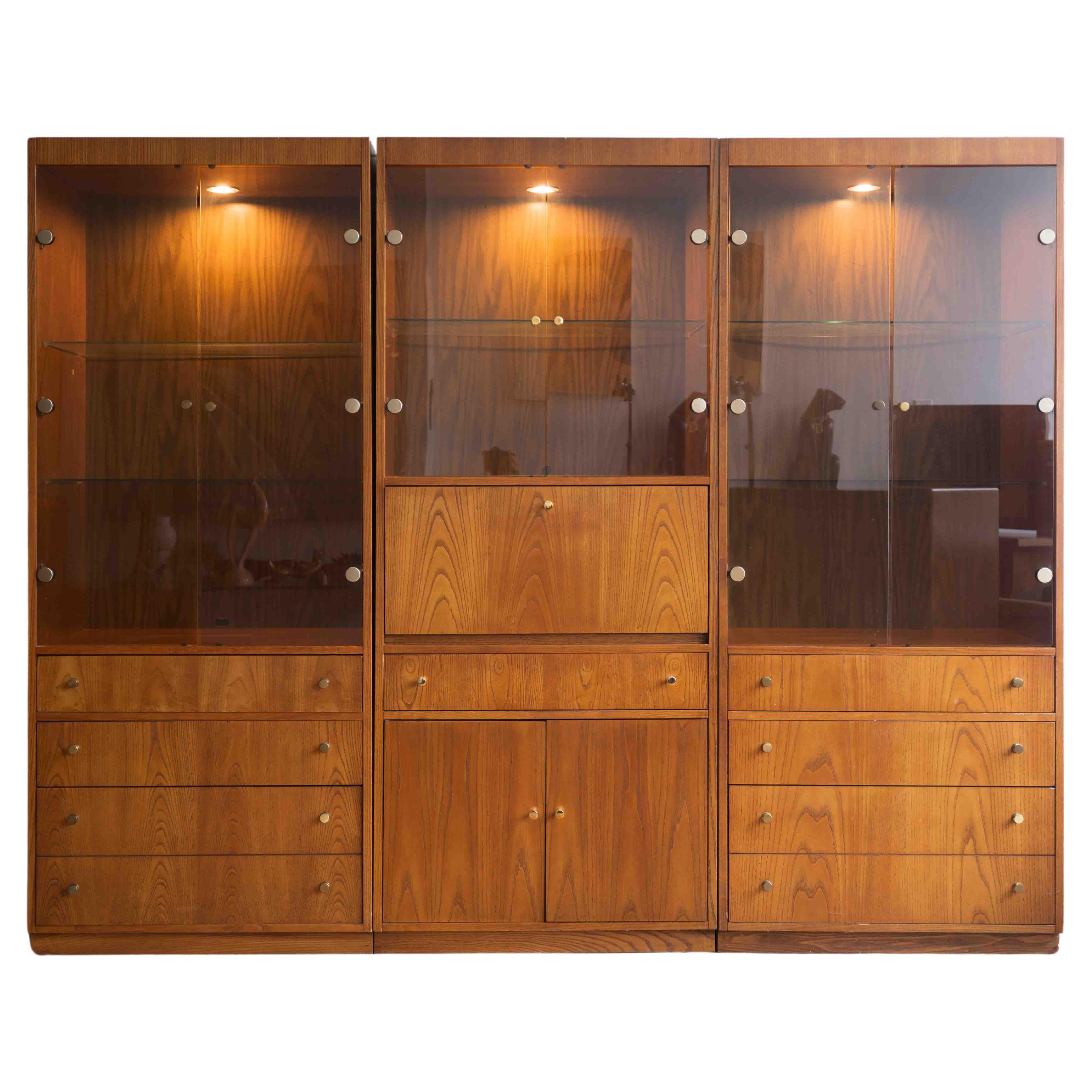 Mid-century 3 bay lighted display cabinet / wall unit with desk For Sale
