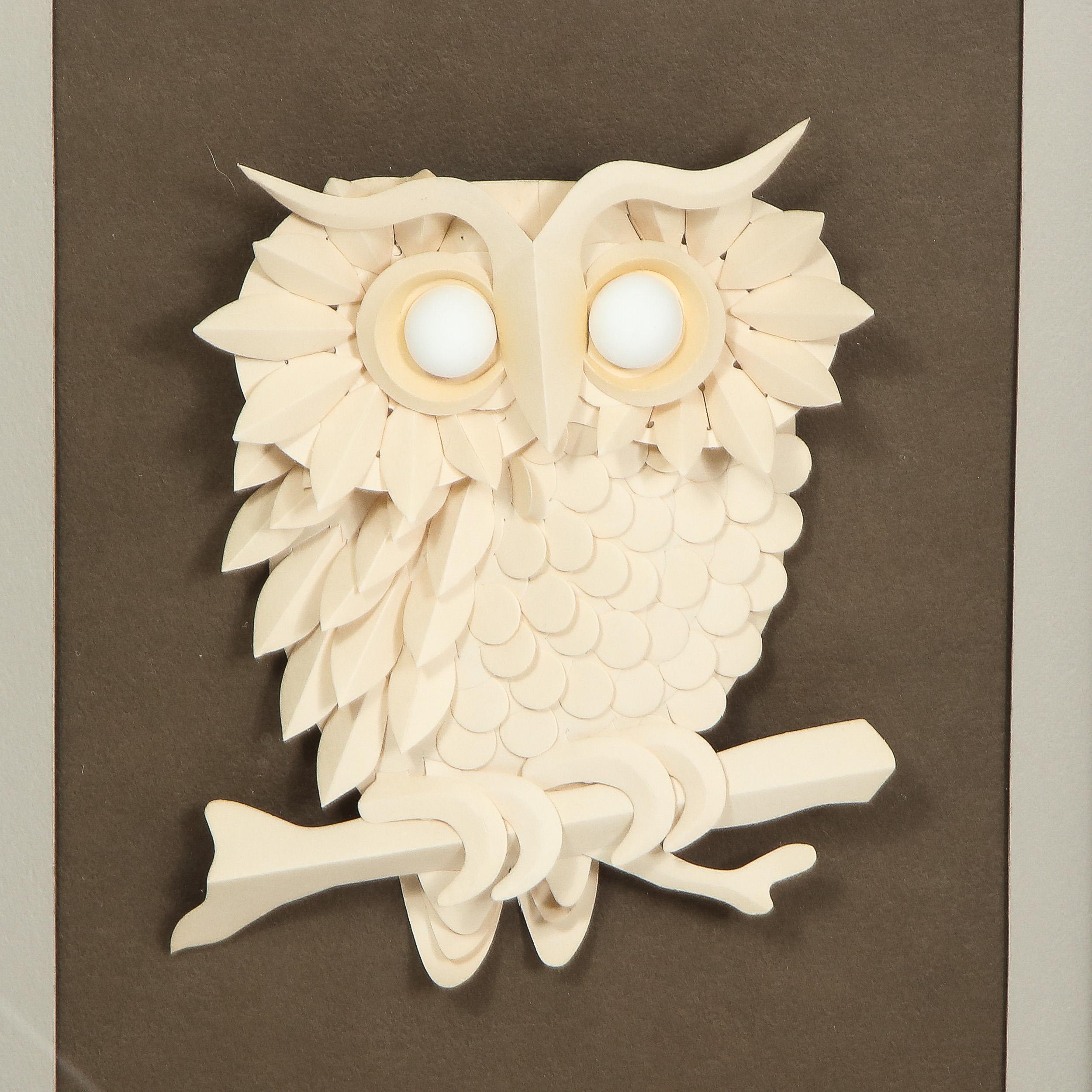 This sophisticated Mid-Century Modern mixed-media artwork was realized by the esteemed artist Jack Eisner in the United States, circa 1975. It features a stylized owl executed in cream paper in relief lending it a highly sculptural quality presented