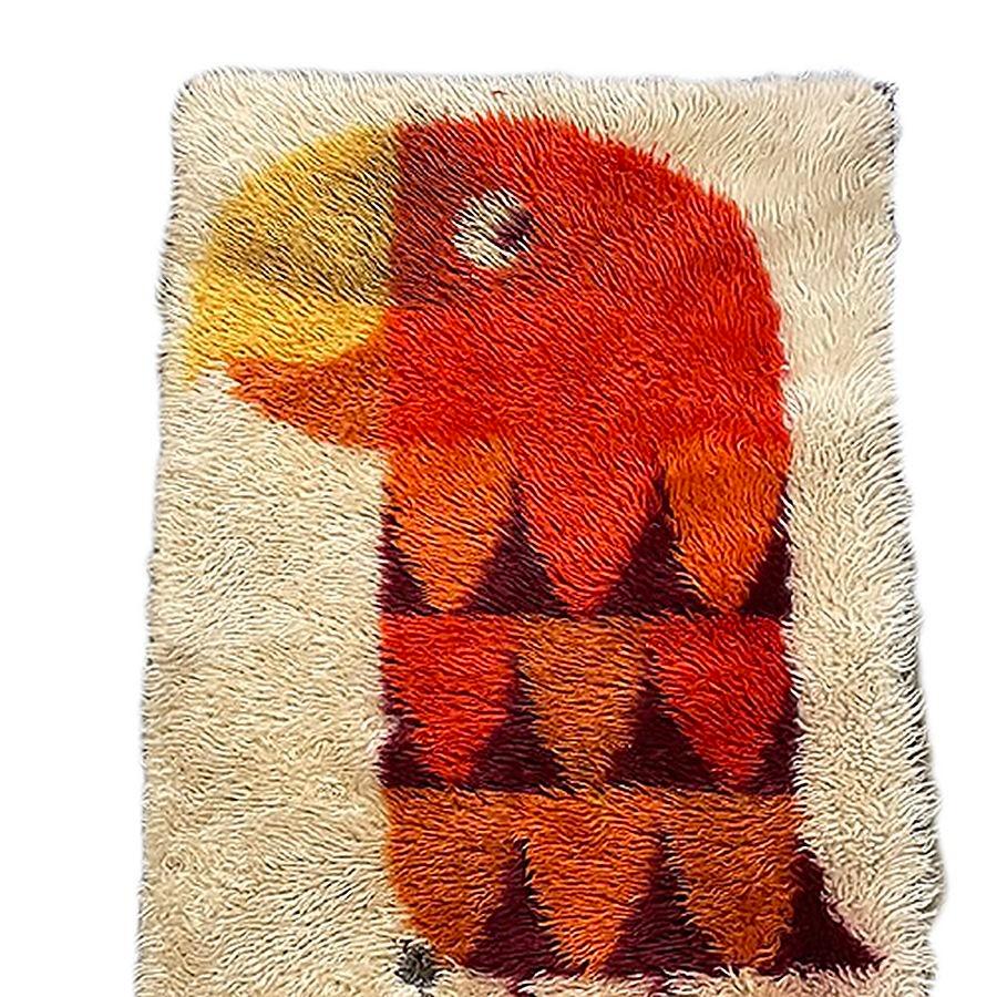Hand-hooked late Mid-century wool tapestry rug featuring a Modernist abstract portrait of a Parrot done in yellow, orange, and brown against a beige background It is an excellent piece for accenting your room with color-infused textiles along any