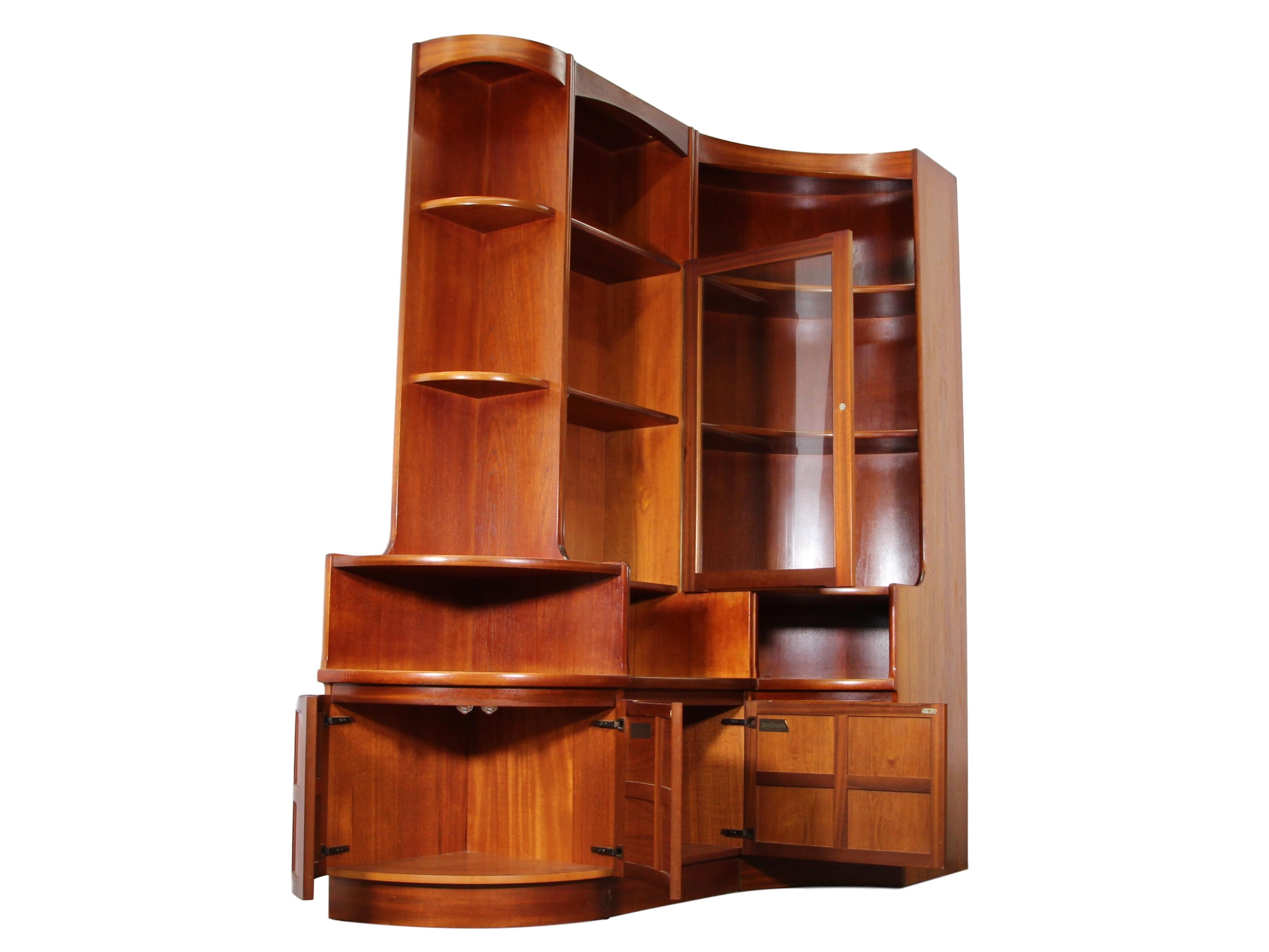 Fantastic teak wall unit made by Nathan Furniture. Made in England. Features 1 end unit, 1 corner unit and 1 smaller main unit with a glass door. Original labels and tags are attached. 

Very good vintage condition. The unit appears to have been