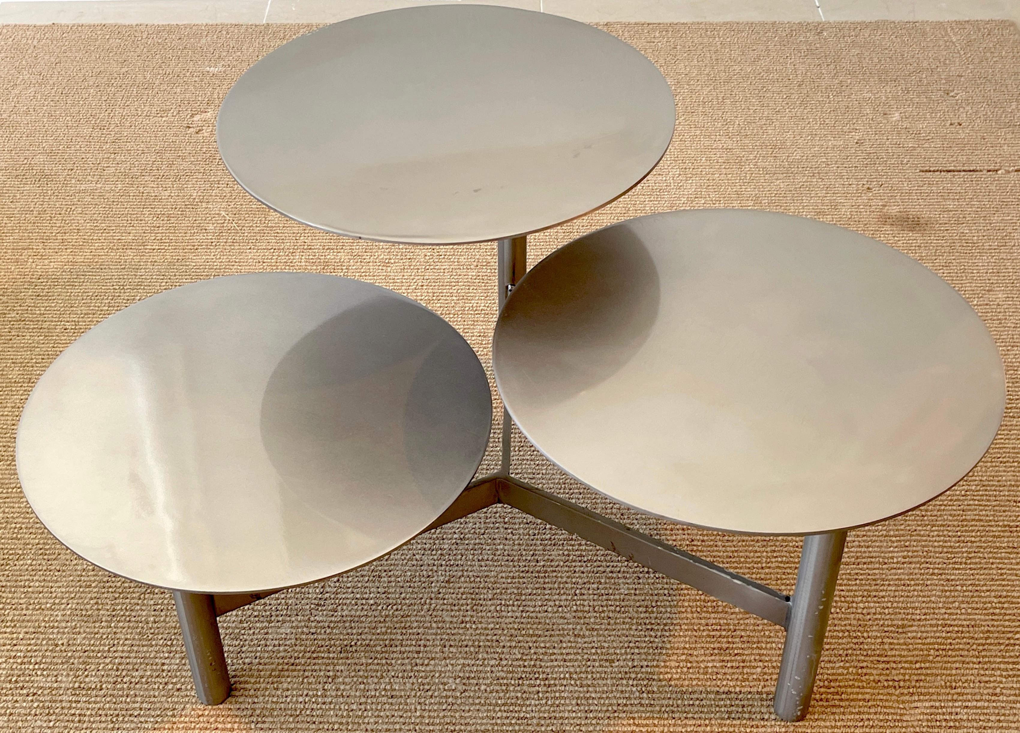 Mid Century 3-Tiered Steel kinetic coffee table/side table 
USA, Circa 1970s

Three graduated (18.5 x 14 x 10.5 -Inches high) 18-Inch expandable and contractable circular steel disks/ tables, raised on three columns, on a 
 triangular base. 

