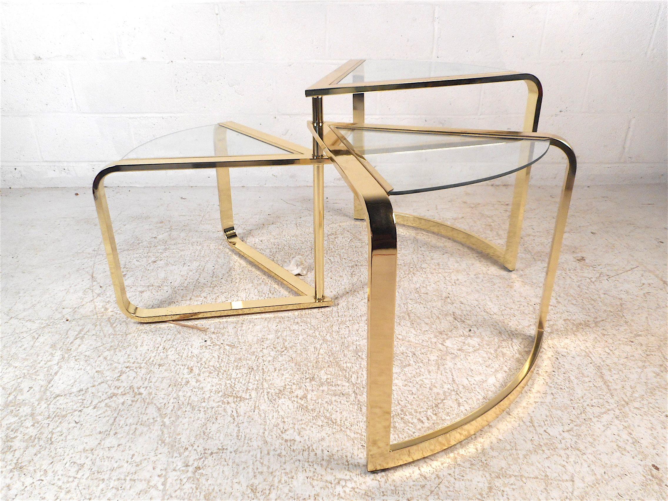 Stylish midcentury three-tiered swiveling coffee/cocktail table. Sleek and sturdy brass frame, three glass inserts in each tier serve as table surfaces. A unique addition to any modern interior. Please confirm item location with dealer (NJ or NY).