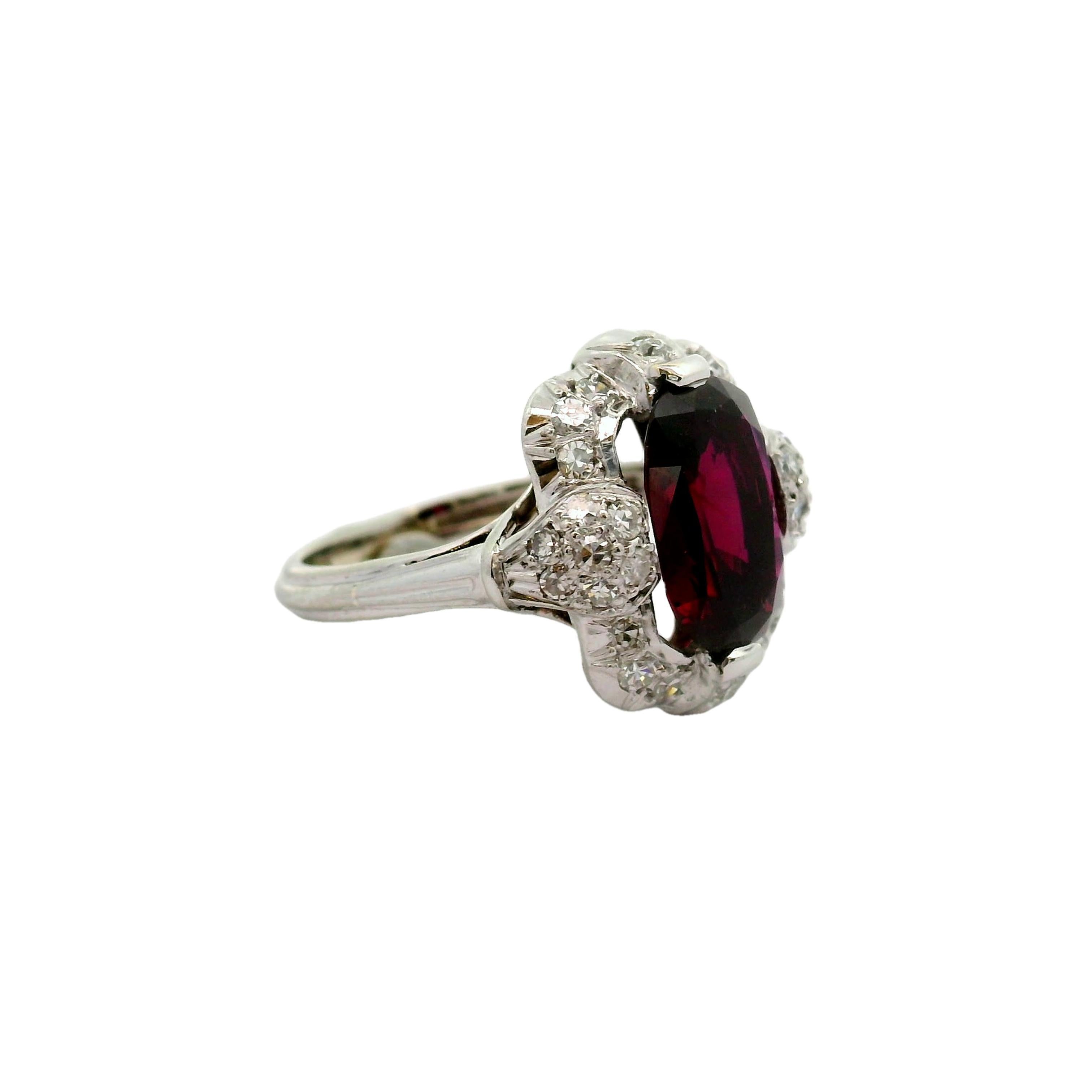 A captivating ruby, weighing approximately 3 carats, commands attention in this exquisite ring. The ruby, expertly cut in a cushion shape, displays a rich and intense red hue that is completely natural. It is certified by the GIA as natural, with no