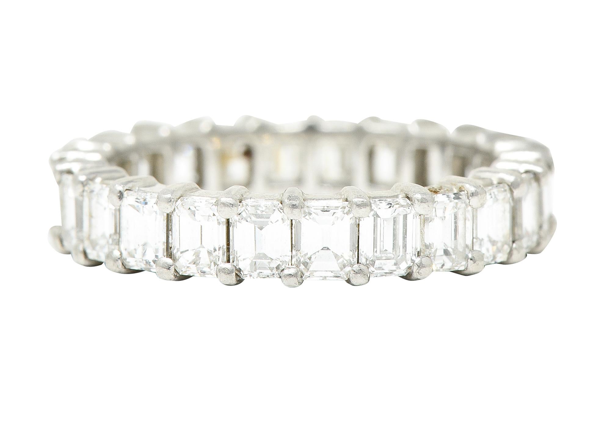 Eternity band ring is set with emerald cut diamonds. Fully around via shared prongs. Weighing in total approximately 3.00 carats - G/H color with VS2 clarity. Tested as platinum. Circa: 1950s. Ring Size: 6 & not sizable. Measures North to South 4.0