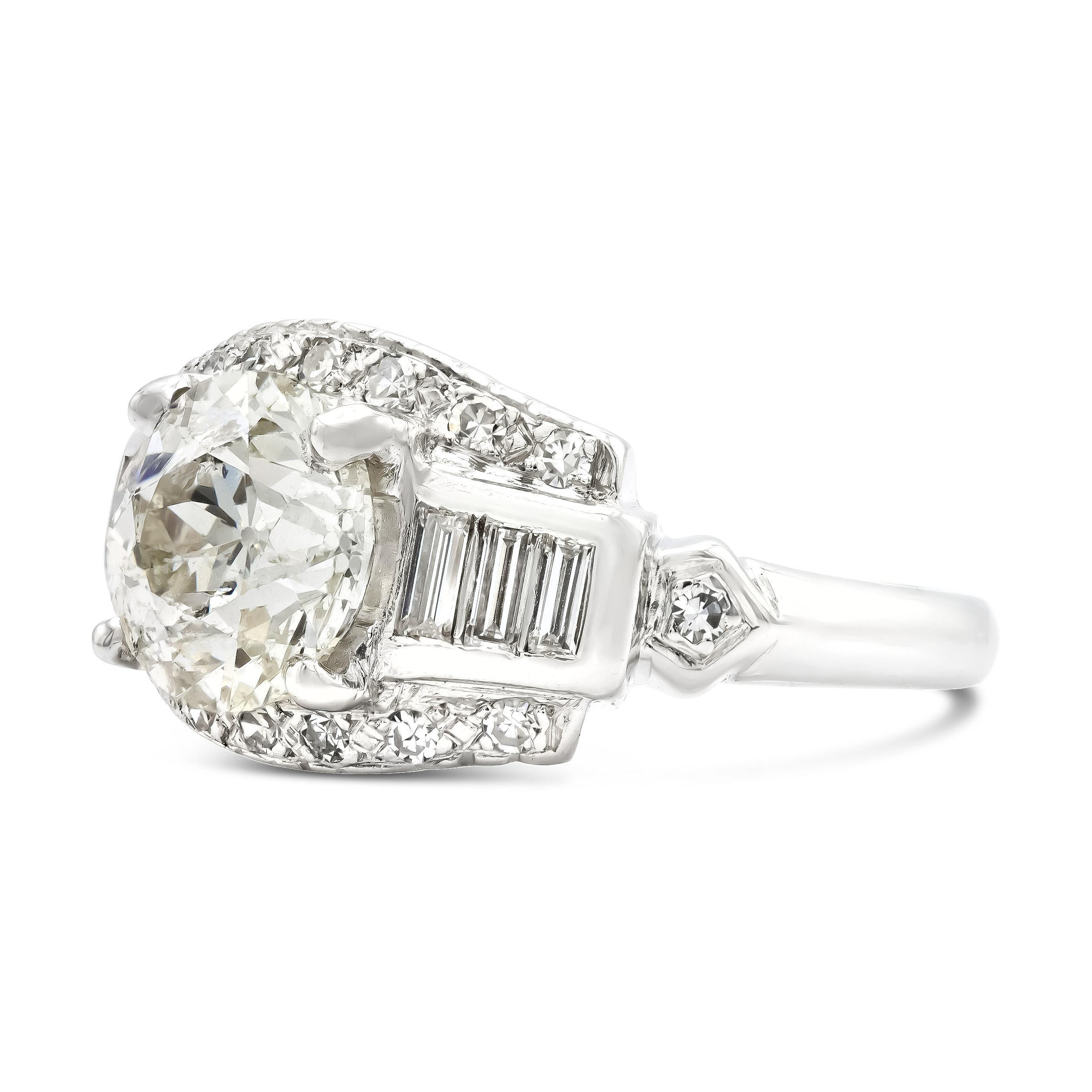 There is so much to love about the bright old European cut that centers this vintage engagement ring. The 3 carat diamond has those classically antique facet patterns that we so appreciate. We love how the side baguettes, fashioned in a super cool