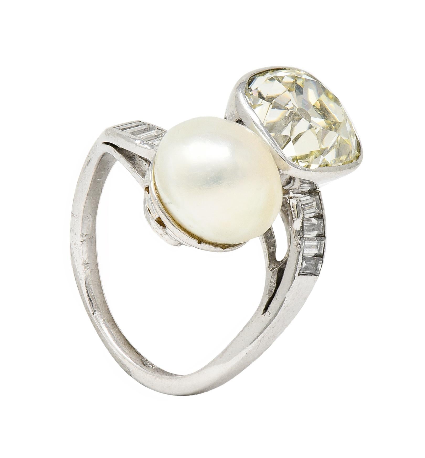 Bypass style ring terminates with a pearl and an old mine cut diamond - both with pierced baskets 
Pearl is button shaped and Natural Saltwater Pinctada
White in body color with strong iridescence
Diamond weighs approximately 3.20 carats 
U/V color