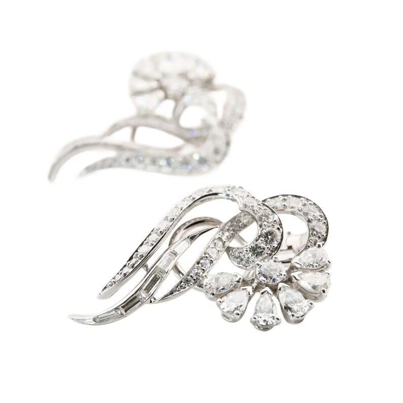 Aston Estate Jewelry Presents:

A scintillating pair of mid century diamond earrings featuring a beautiful combination of round, baguette, and pear shaped diamonds. Designed as a fan of pear shaped diamonds encircling a prong set brilliant, flanked