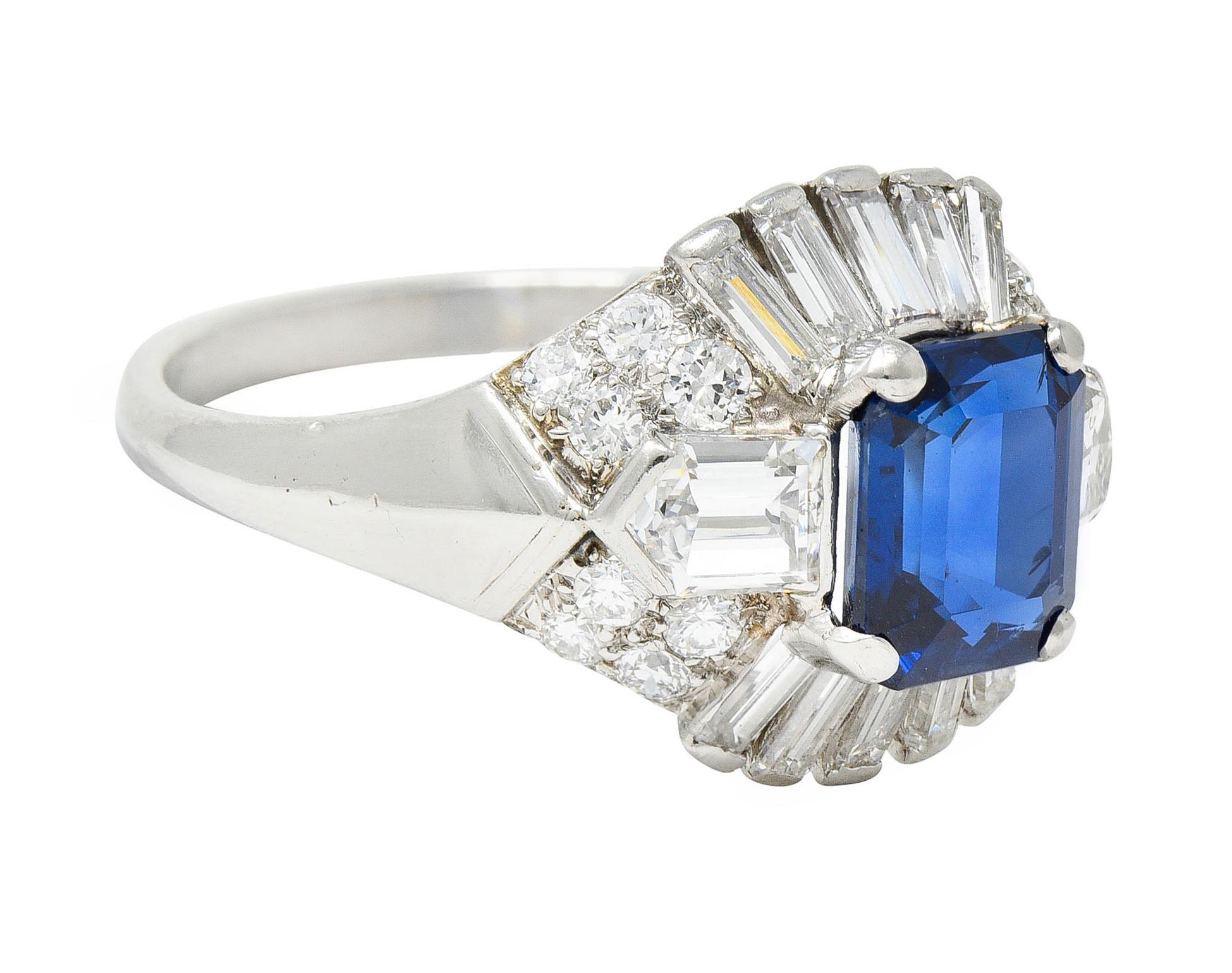 Bombè shaped ring centers an octagonal cut sapphire weighing 2.49 carats

Strongly royal blue in color with no indications of heat - Cambodian in origin

Flanked East/West by bullet cut diamonds and surrounded North/South by elongated baguette cut