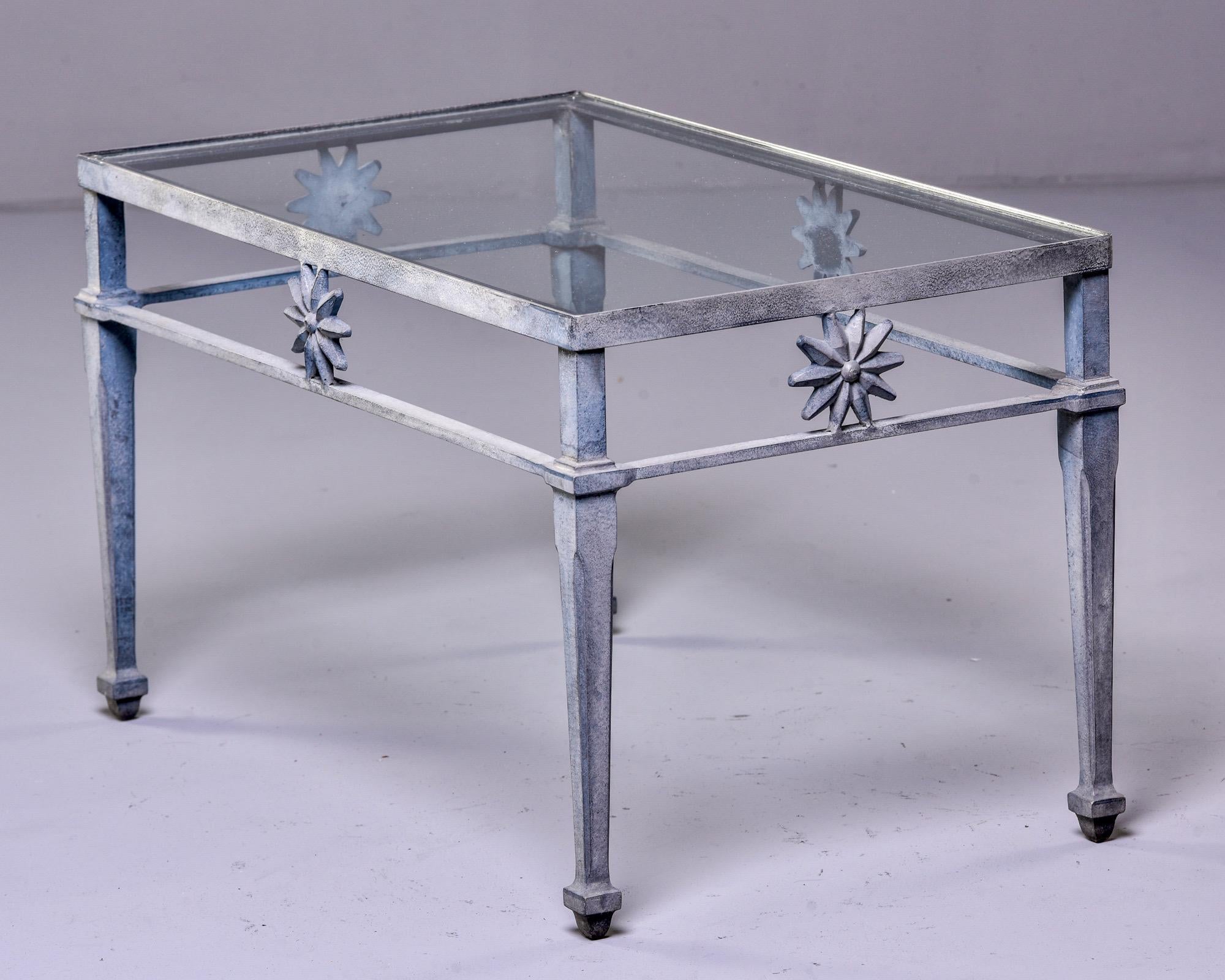 4-piece patio set attributed to Molla in cast aluminum with a zinc finish, circa 1970s. Settee, pair of armchairs and glass-topped coffee table feature neoclassical motifs including swag-draped seat backs, sunbursts and dolphin supports. Very good