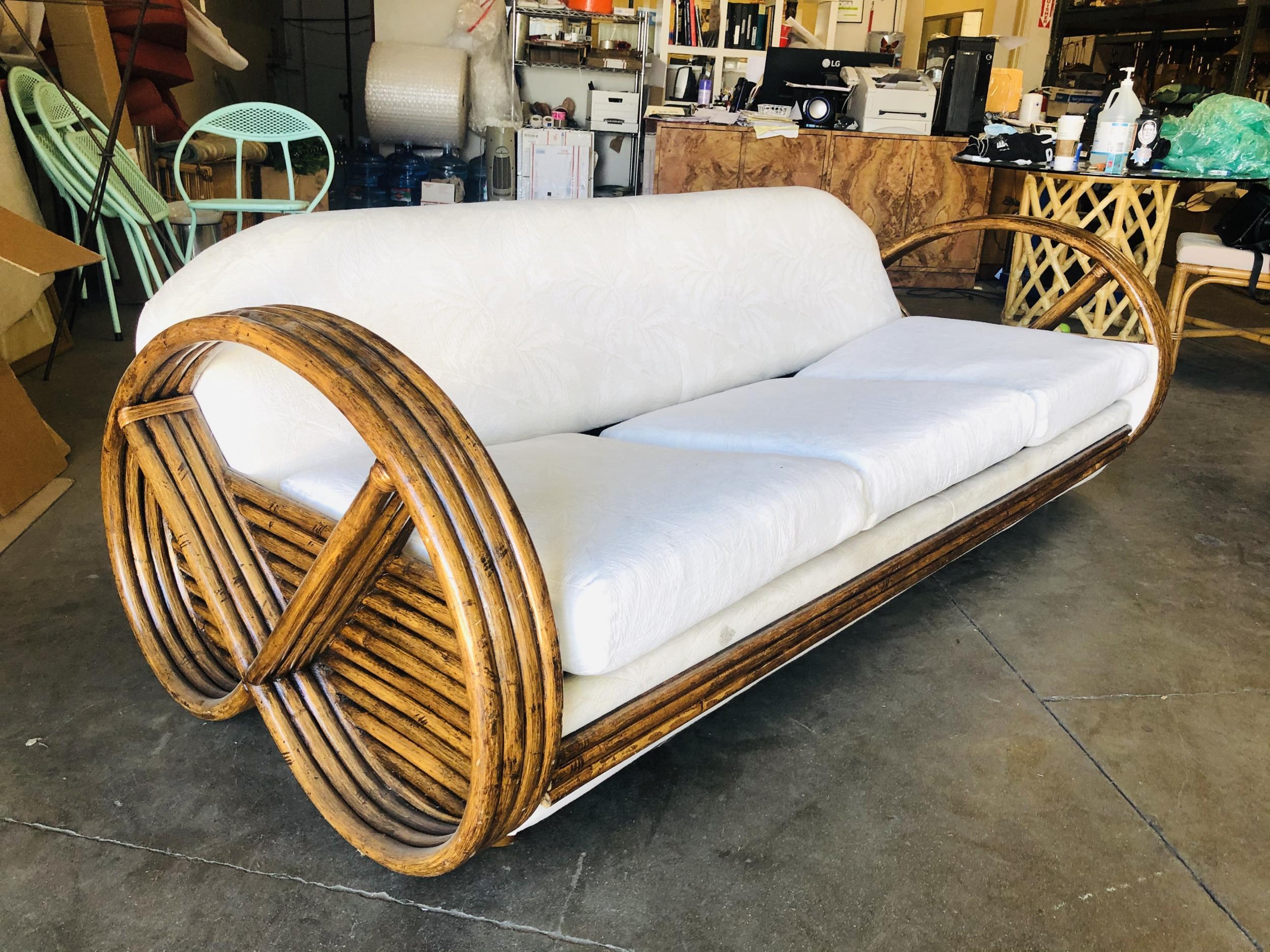 Vintage circa 1960 rattan 4 Strand round pretzel arm 3 seat sleeper sofa with pullout bed in the manner Of Paul Frankl. 

Restored to new for you. 

This was made by Ritts co, Tropitan , Herb Sr. and Shirley Ritts. Shirley was an American
