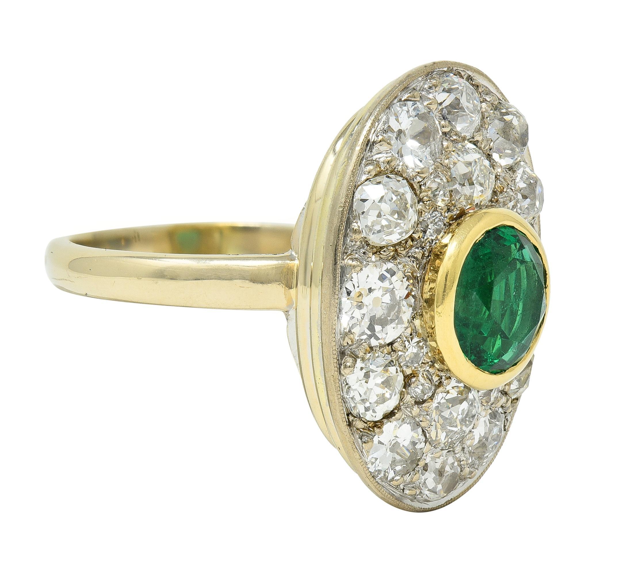 Centering a round cut emerald weighing 1.49 carats - transparent medium green in color
Natural Zambian in origin displaying minor clarity enhancement - F1
Set in a yellow gold bezel atop a recessed oval-shaped platinum form
Bead set with clustered