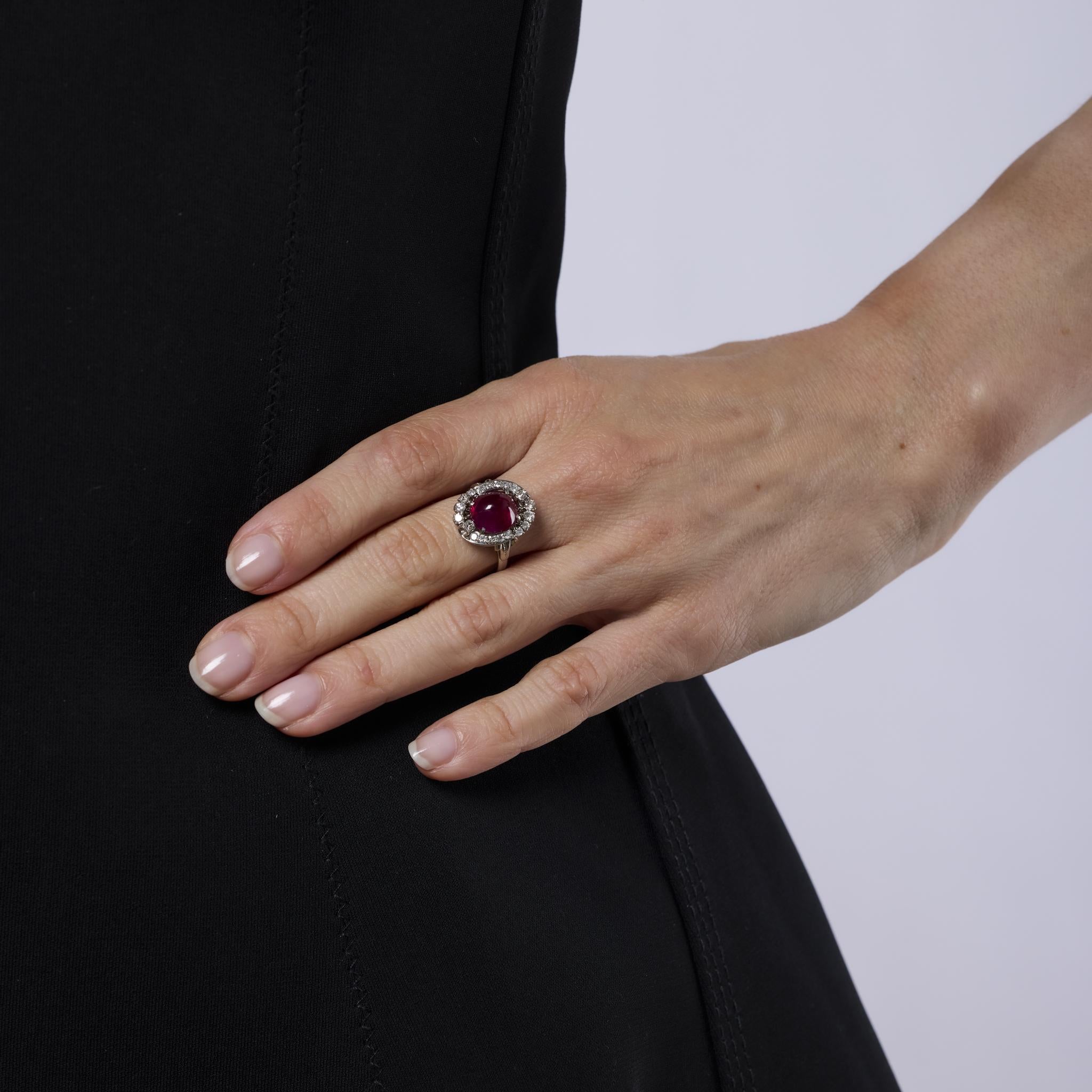 This striking Mid Century ring features a GIA-certified 4.30 carat Burmese cabochon ruby, accented by bright white diamonds. Set in platinum, it embodies the rich color and elegant craftsmanship of the 1950s.