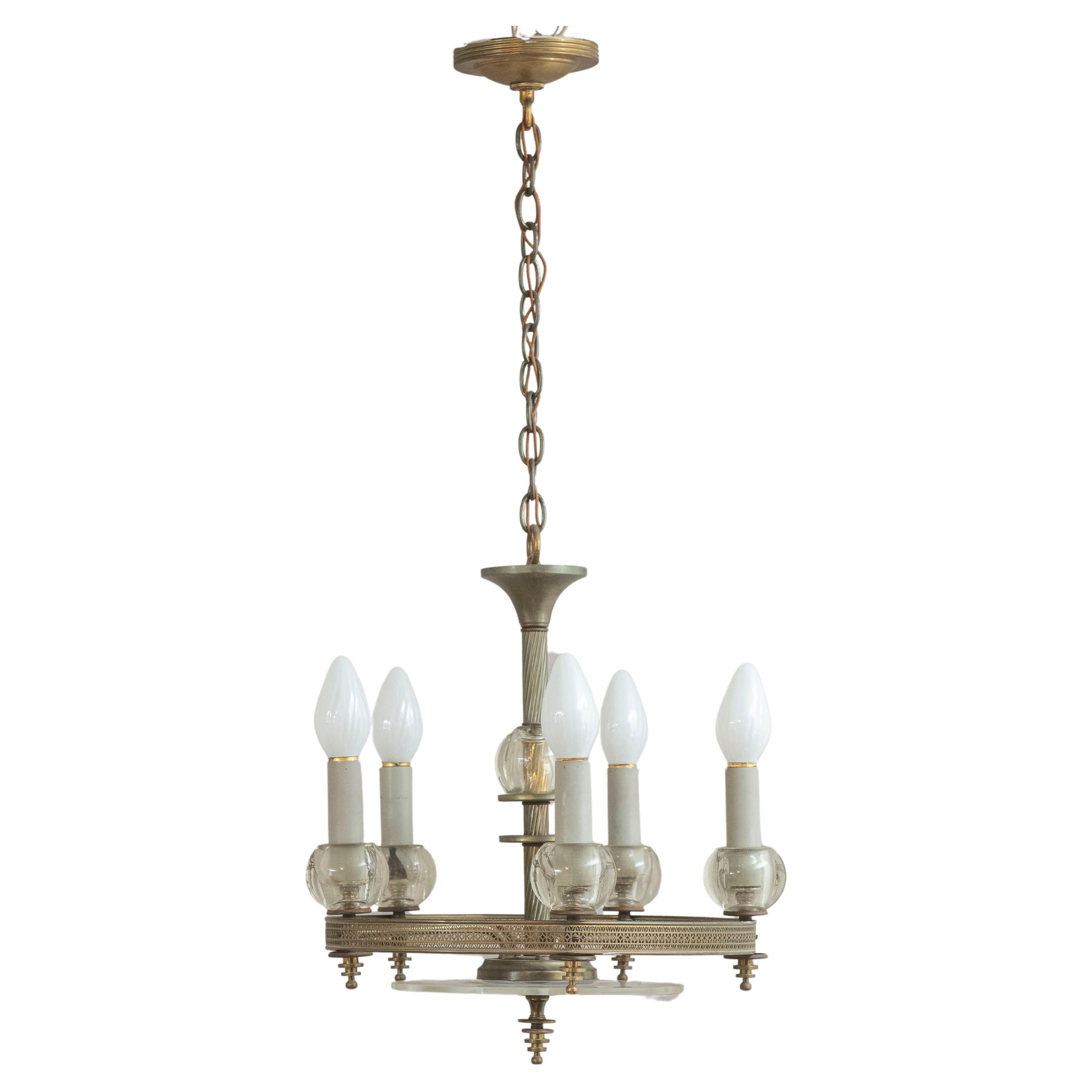  This clean looking 1940's chandelier will give you plenty of light and is a nice quality piece of lighting. Having 5 sockets with silvered metal and glass make for a functional and reasonably priced chandelier.