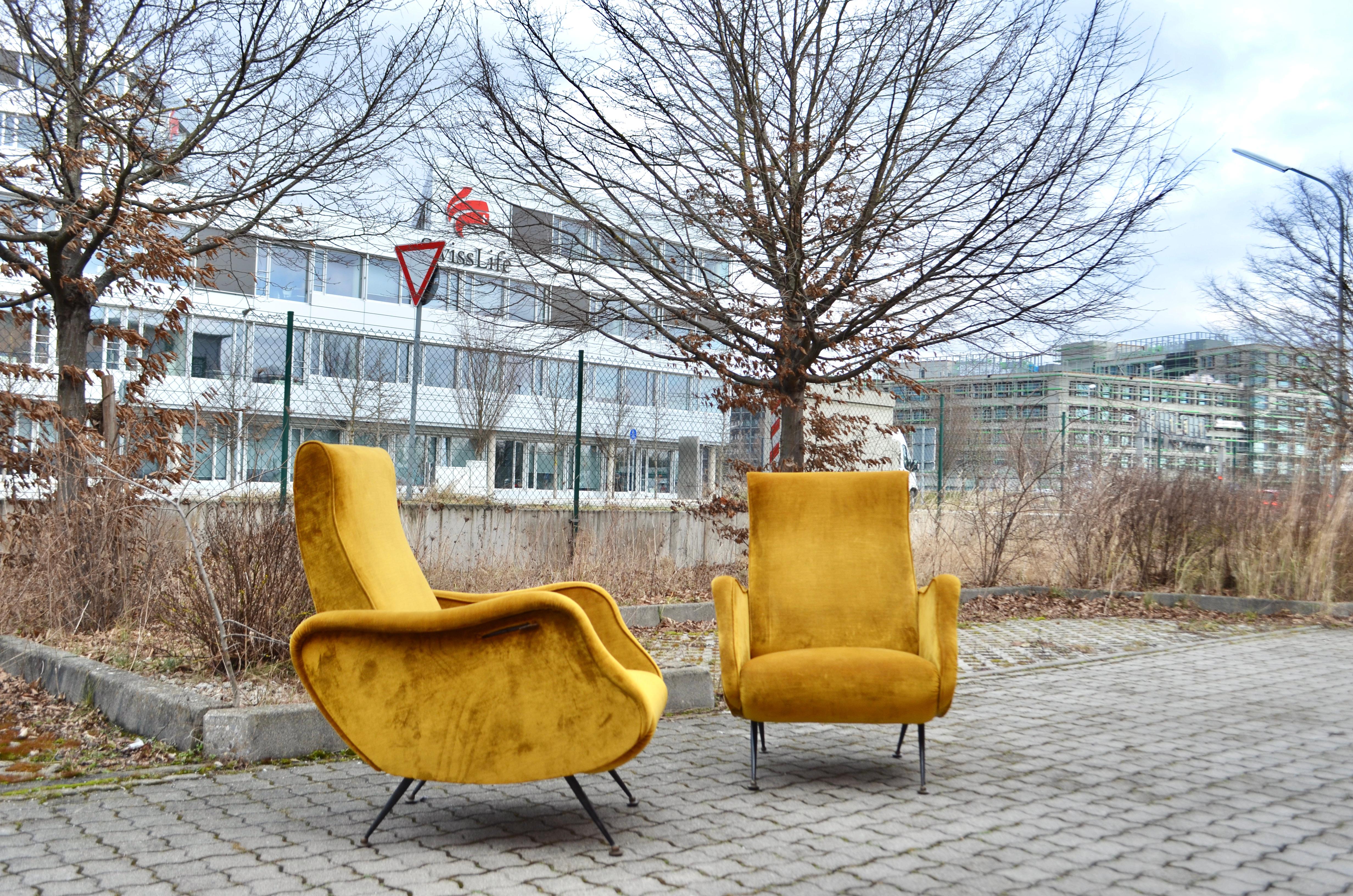 This gorgeous mid century Italian armchairs comes fromthe 50ties and were manufactured in Italy. 
The designer and manufacturer are yet still unknown.
It was upholstered a few years ago with beautiful mustard velvet fabric.
The back are