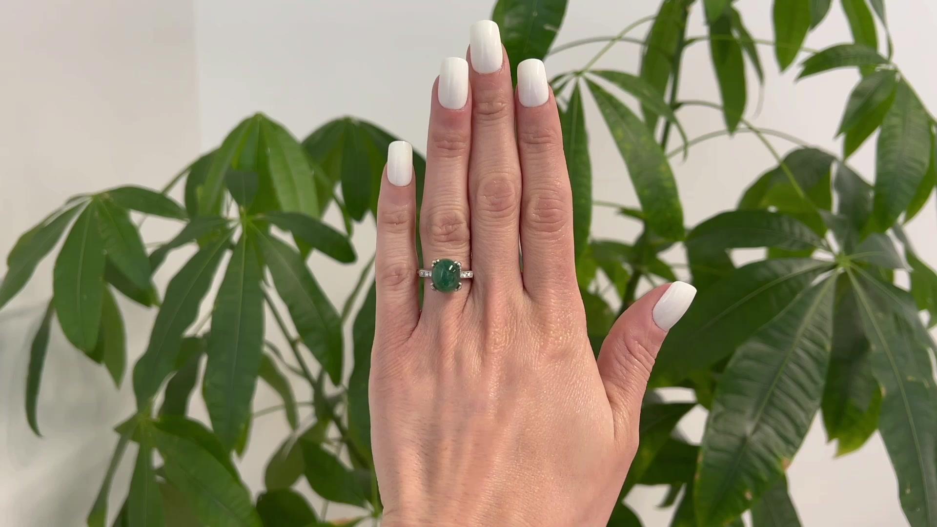 One Mid Century 5.15 Carats Emerald Diamond Platinum Ring. Featuring one cabochon cut emerald of 5.15 carats. Accented by six round brilliant cut diamonds with a total weight of approximately 0.30 carat, graded F color, VS clarity. Crafted in