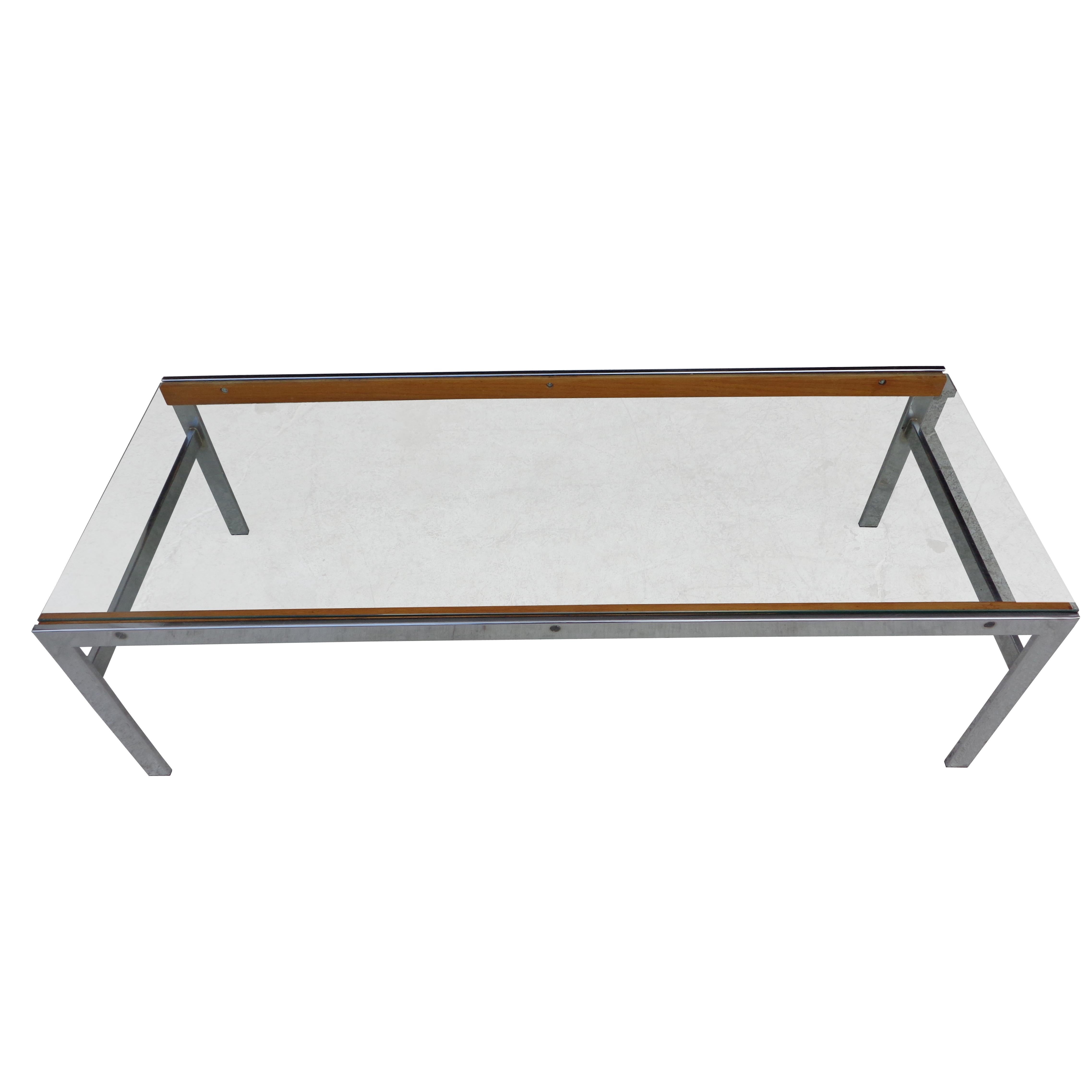 Mid century glass chrome wood coffee table

Interesting mix of glass, chrome and wood in this 54