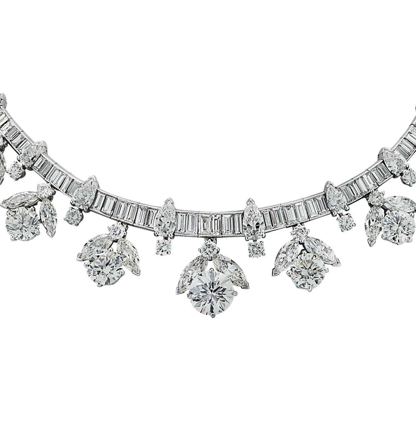 Superb mid-century diamond cluster necklace crafted in platinum, showcasing 262 mixed cut diamonds weighing approximately 56.50 carats total. Round brilliant and emerald cut diamonds adorned with diamond flower clusters, sweep around the neck in a