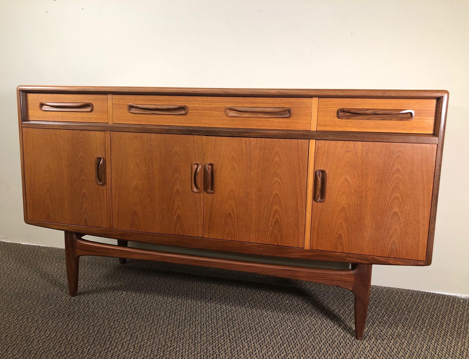 Outstanding small teak credenza. It was designed in the 1960s by Victor Bramwell Wilkins for G Plan's Fresco Range. It has original light grey fabric and wood dividers in the top drawer.

Style: Danish Modern.


It is in very good condition.