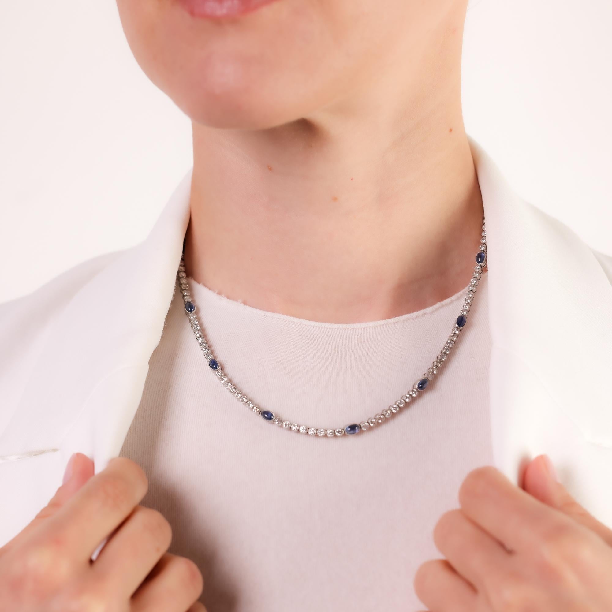 This stunning Mid Century necklace dazzles with 16 deep blue cabochon sapphires and 119 shimmering diamonds, elegantly crafted in platinum for timeless sophistication.

Center stone: 16 cabochon cut blue sapphires 
Total sapphire weight: