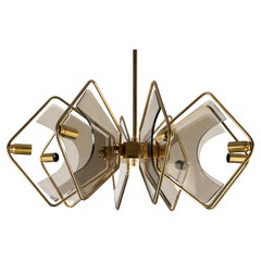 Mid-Century 8 arms Gino Paroldo chandelier in brass and glass. Italy 1970s