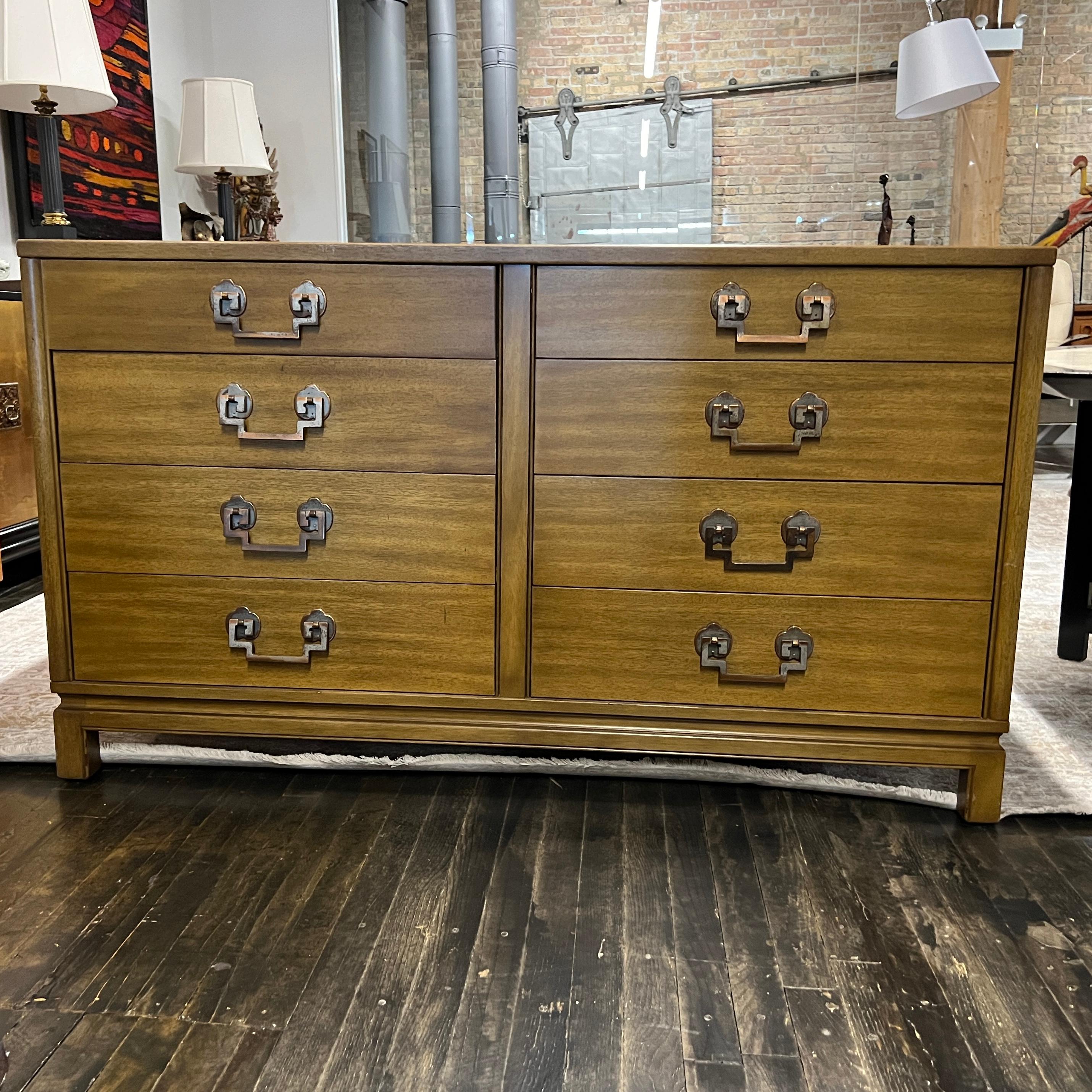 This lovely mid-century 8 drawer dresser was made by Landstrom Furniture Company in Rockford, IL.  The dresser was made with bleached ribbon mahogany and features stunning copper hardware that has a chinoiserie feel to it and lovely patina. 