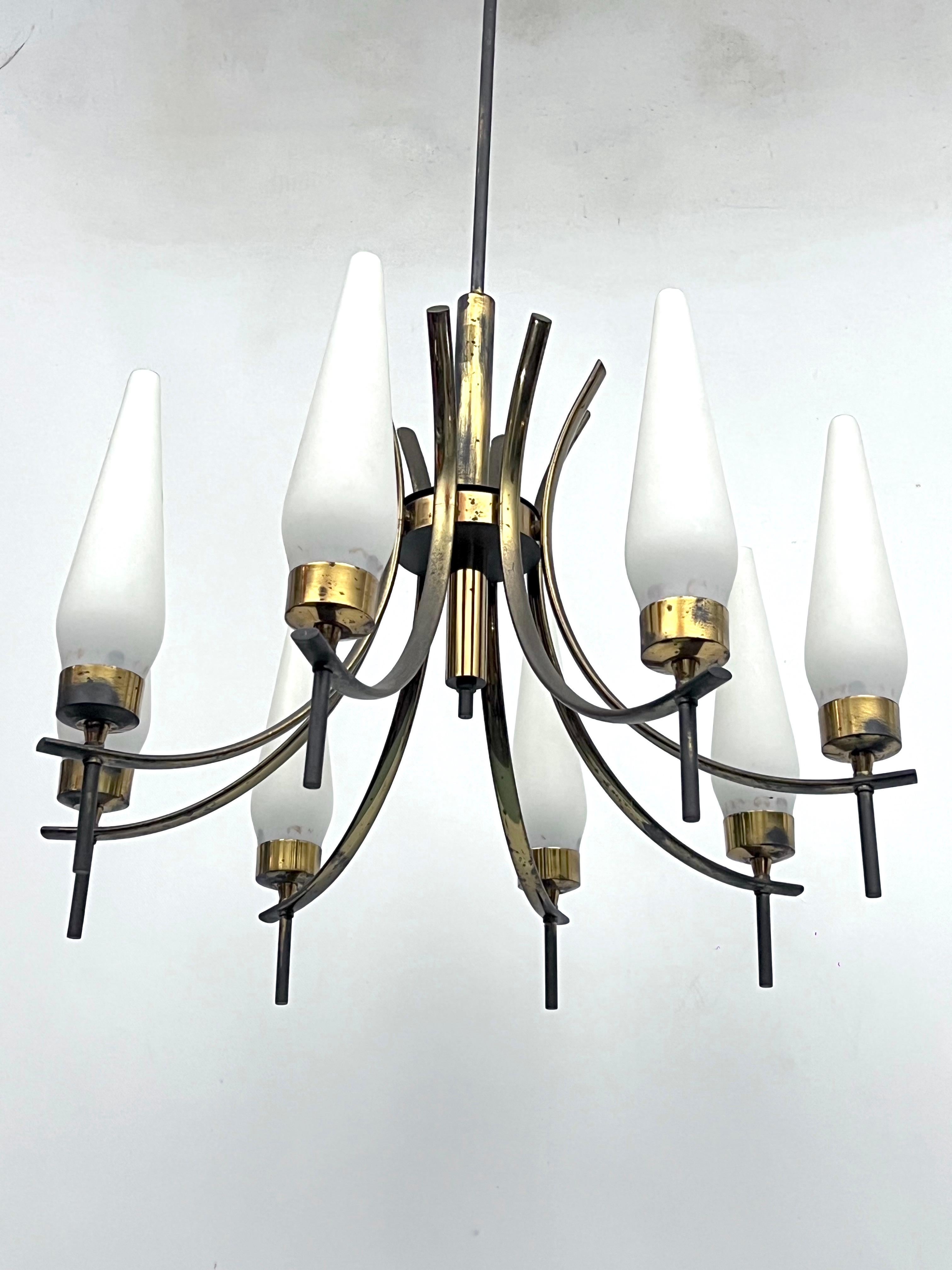 Reminiscent of Arredoluce style, this mid-century chandelier is made from opaline glass, brass, lacquer and it is in good vintage condition with trace of age and use. Oxidation on the brass, glasses with no cracks or chips.Full working with EU