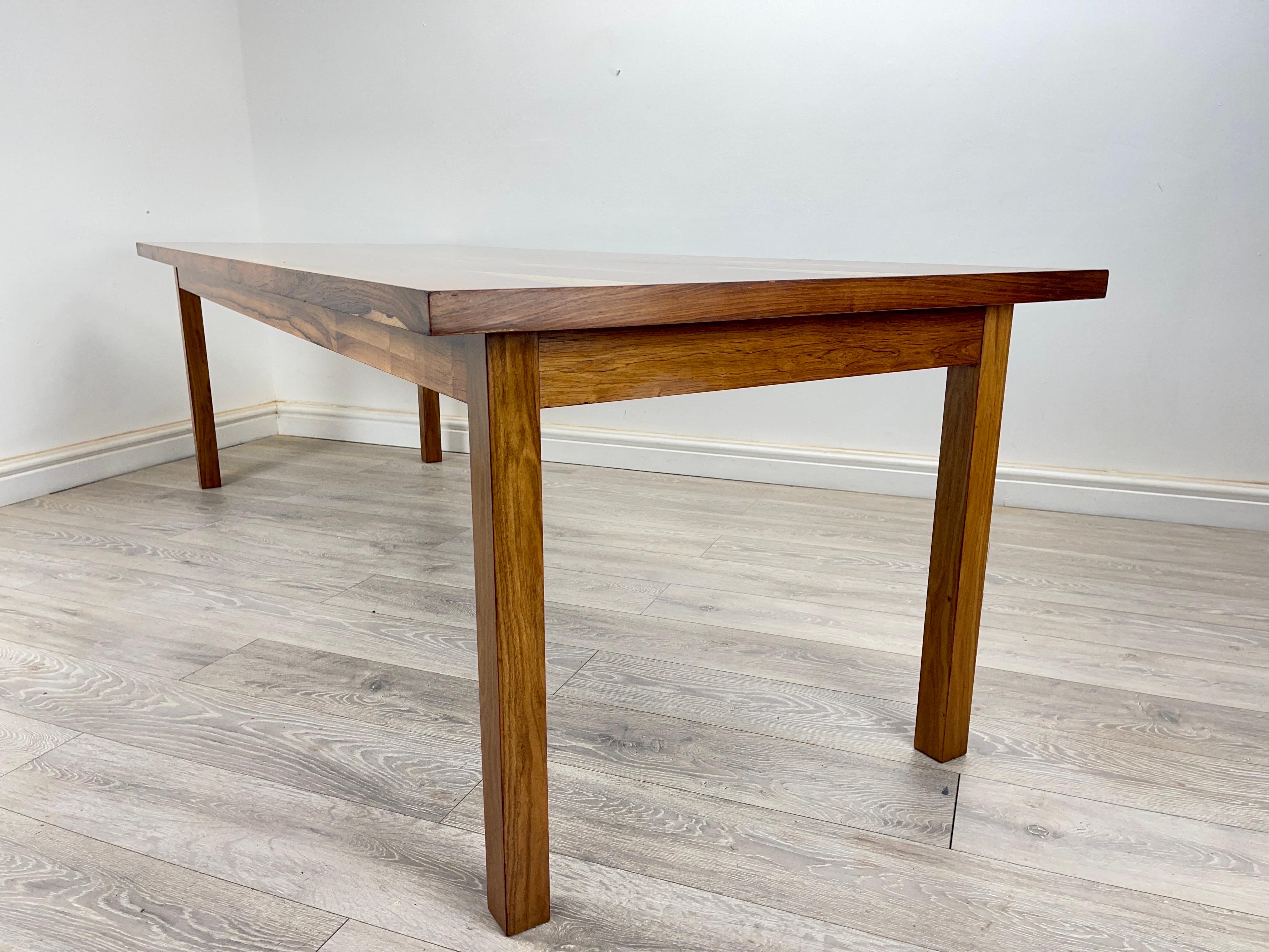 Rosewood Dining
Mid-century Brazilian Rosewood long dining table circa 1960s . The table has stunning rosewood grain throughout, table stands on square rosewood legs . The table top can be easily removed from the frame for easy transportation. The
