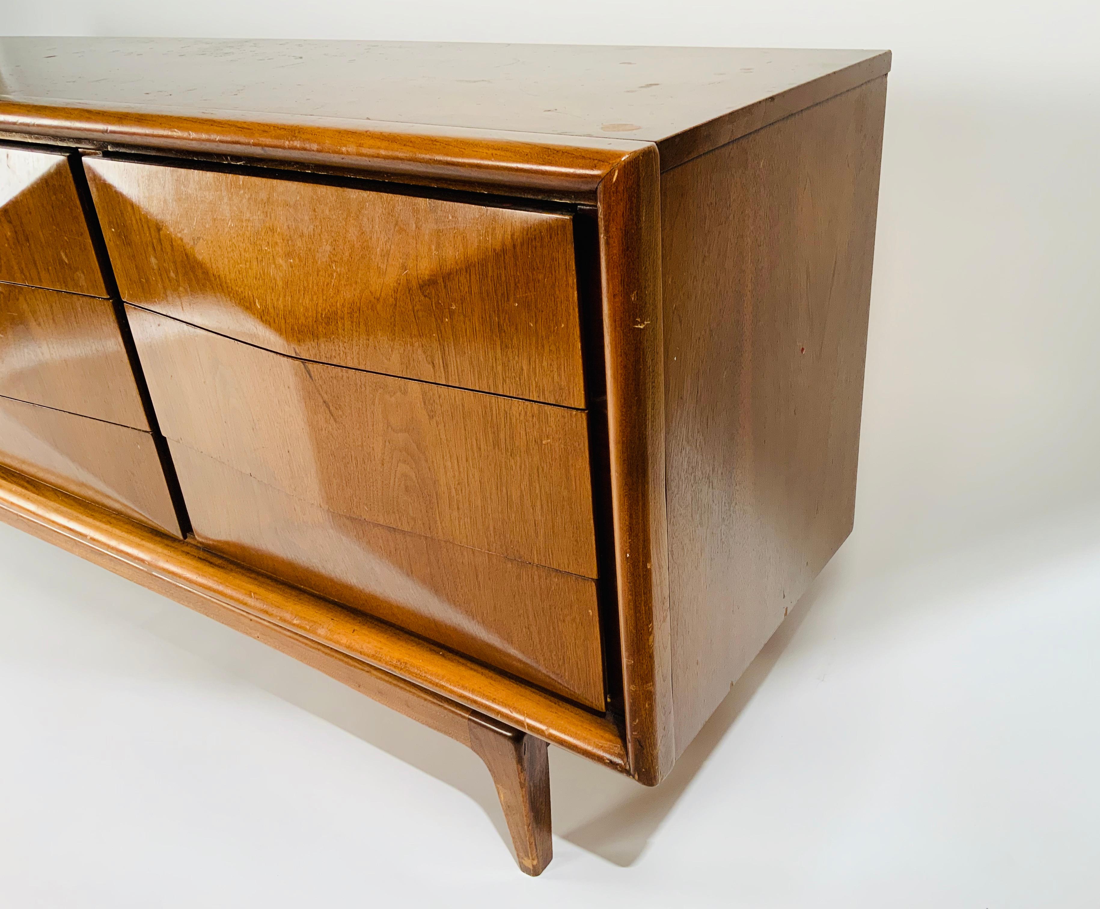 Very chic midcentury walnut dresser with angled fronts. 

Measures: H 30.5 in. x W 74 in. x D 19 in.