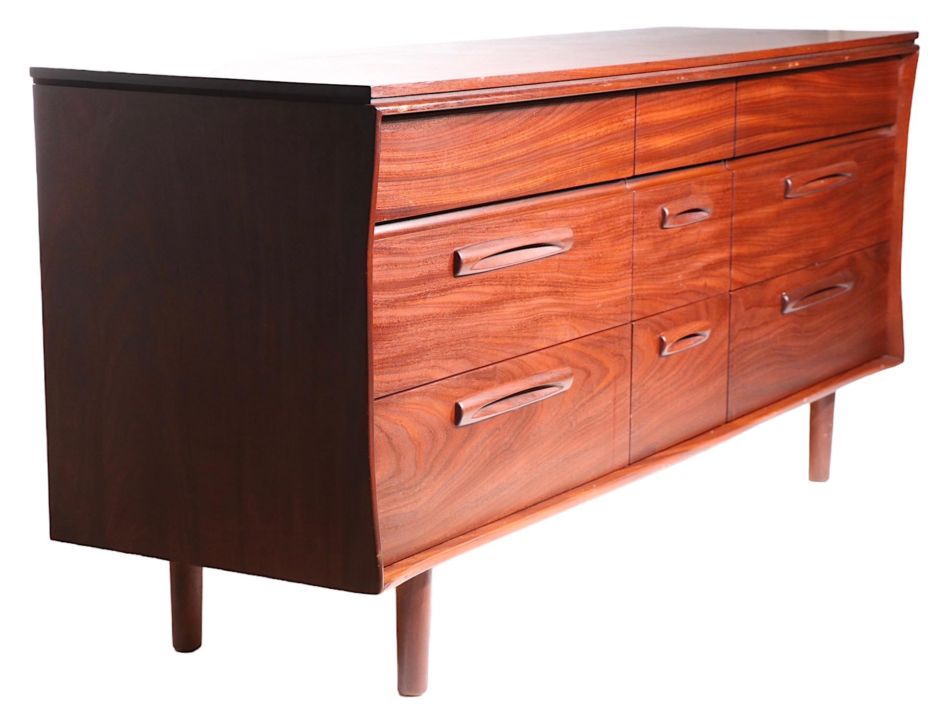 Exceptional nine drawer dresser, of solid teak  wood construction, in clean  original vintage  condition. This exceptional dresser was designed by Jan Kuypers for Imperial Stratford of Canada circa 1960's.  The case features sculpted sides, the
