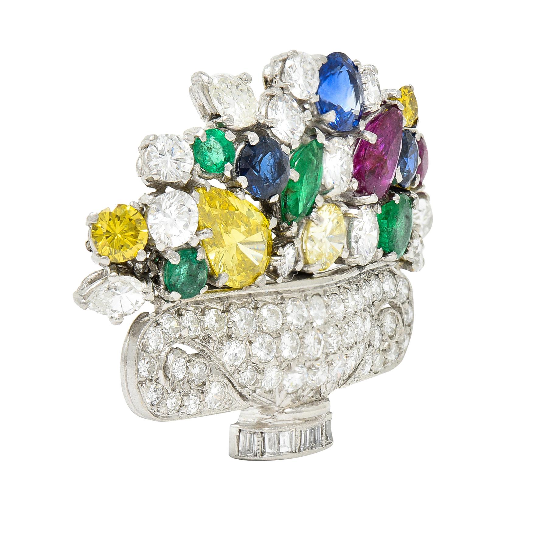 Designed as a vase with an overflowing flower arrangement of diamonds, rubies, emeralds and sapphires. Featuring round brilliant, pear, marquise and baguette cuts - prong, bead and bezel set throughout. Diamonds weigh approximately 5.60 carats total