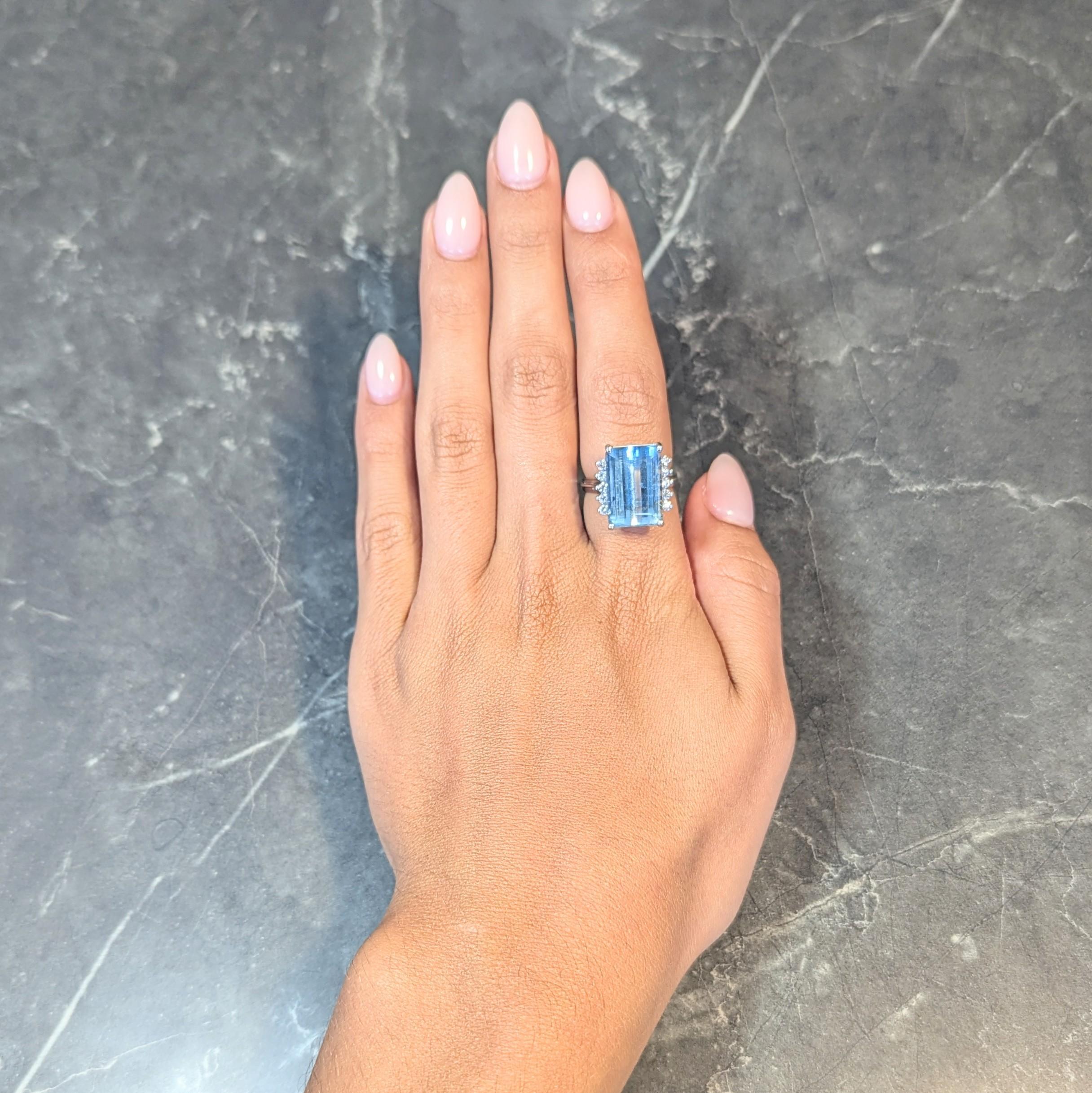 Centering an emerald cut aquamarine weighing approximately 8.75 carats total
Transparent light blue in color and prong set in wire basket
Flanked by rows of transitional cut diamonds
Weighing approximately 0.60 carat total
G/H color with VS2 clarity