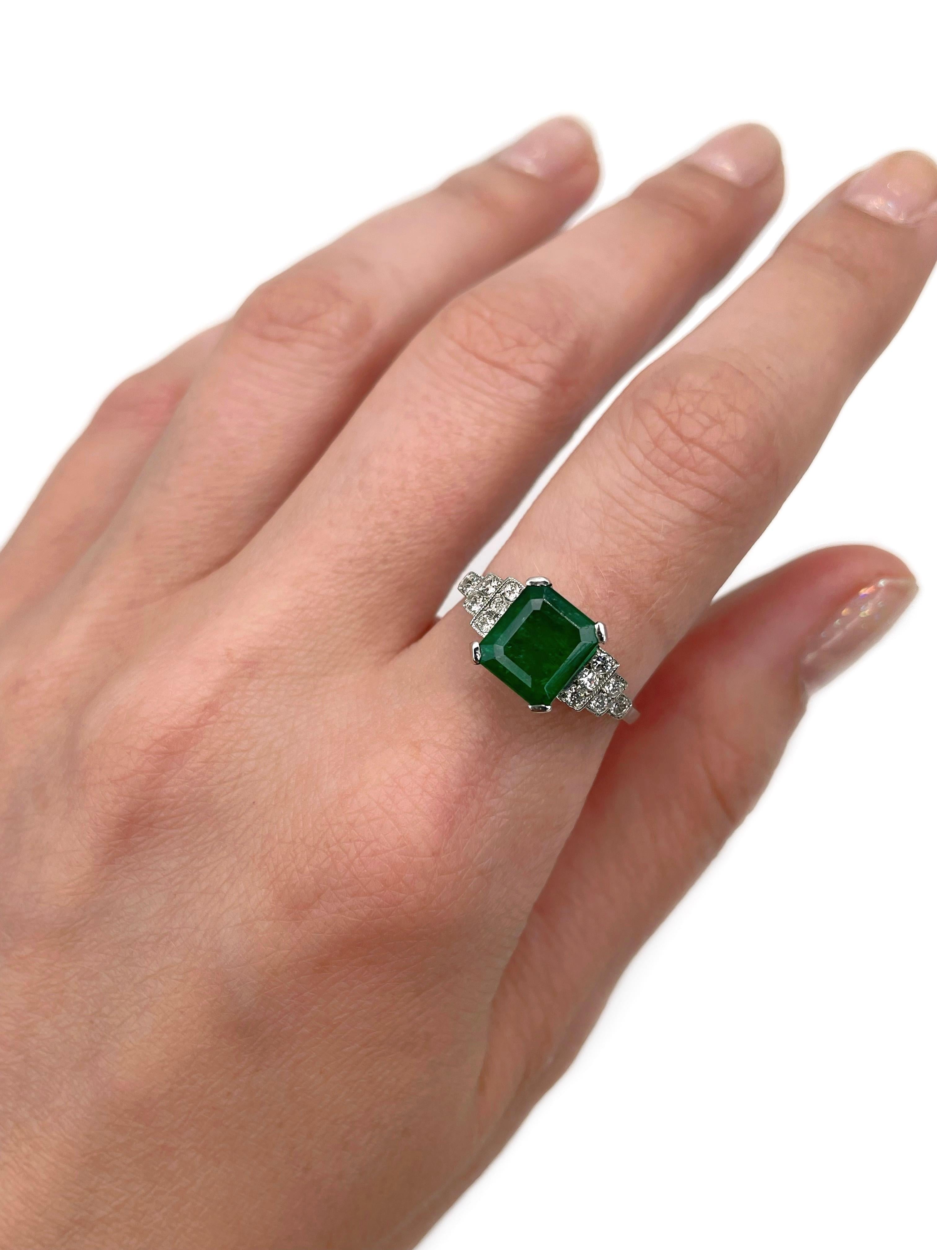 This is a mid-century cocktail ring crafted in 950 platinum. Circa 1950. 

The piece features:
- 1 emerald, emerald cut, 2.00ct, vslbG 7/4, P2
- 12 diamonds, old cut, TW 0.24ct, RW-W, VS-SI

Weight: 4.45g
Size: 17.25 (US 6.75)

IMPORTANT: please ask