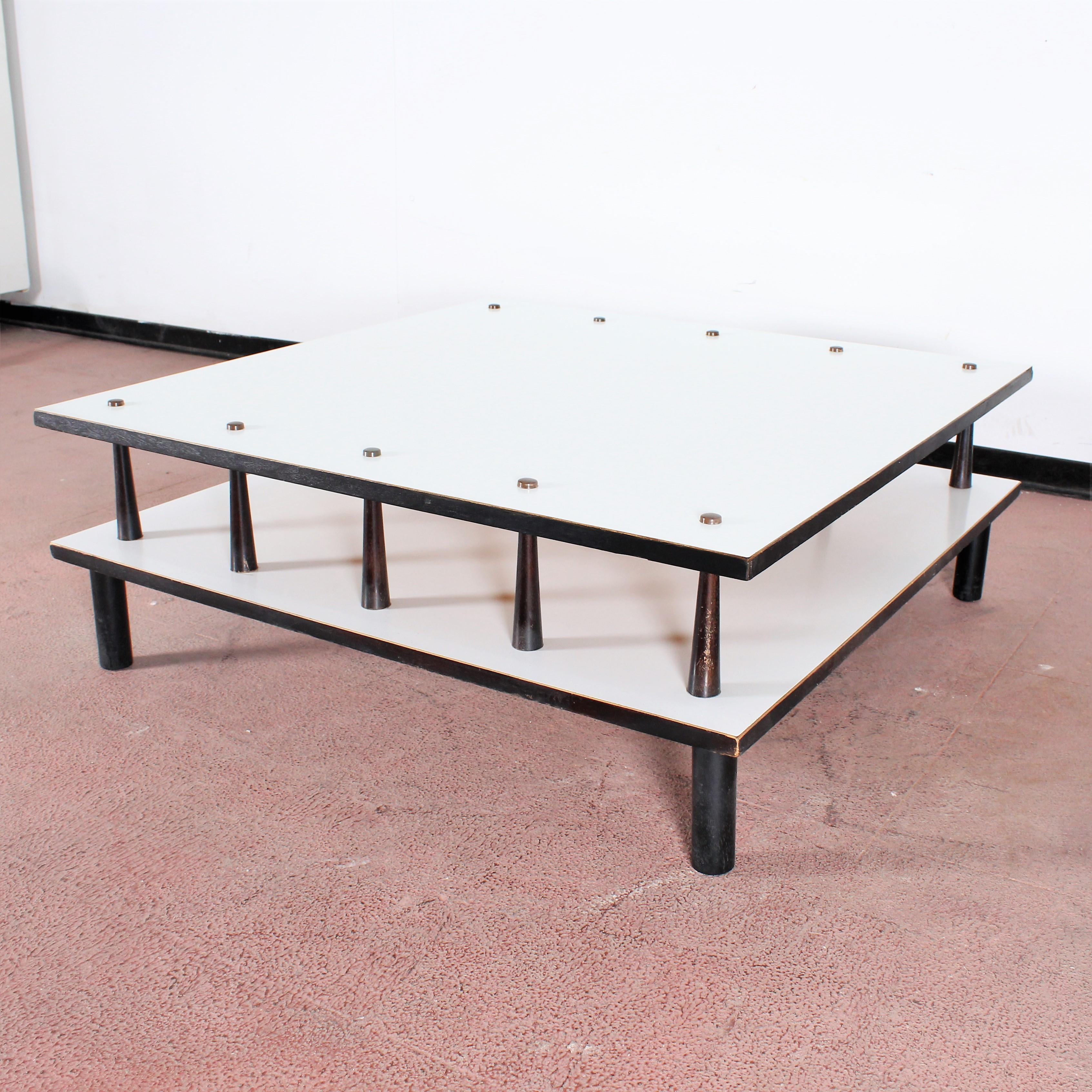 Beautiful white lacquered wood square coffee table with two shelves and supports in the shape of elongated cones. Attributed to Angelo Mangiarotti, 1960s, Italy.
Wear consistent with age and use.
       