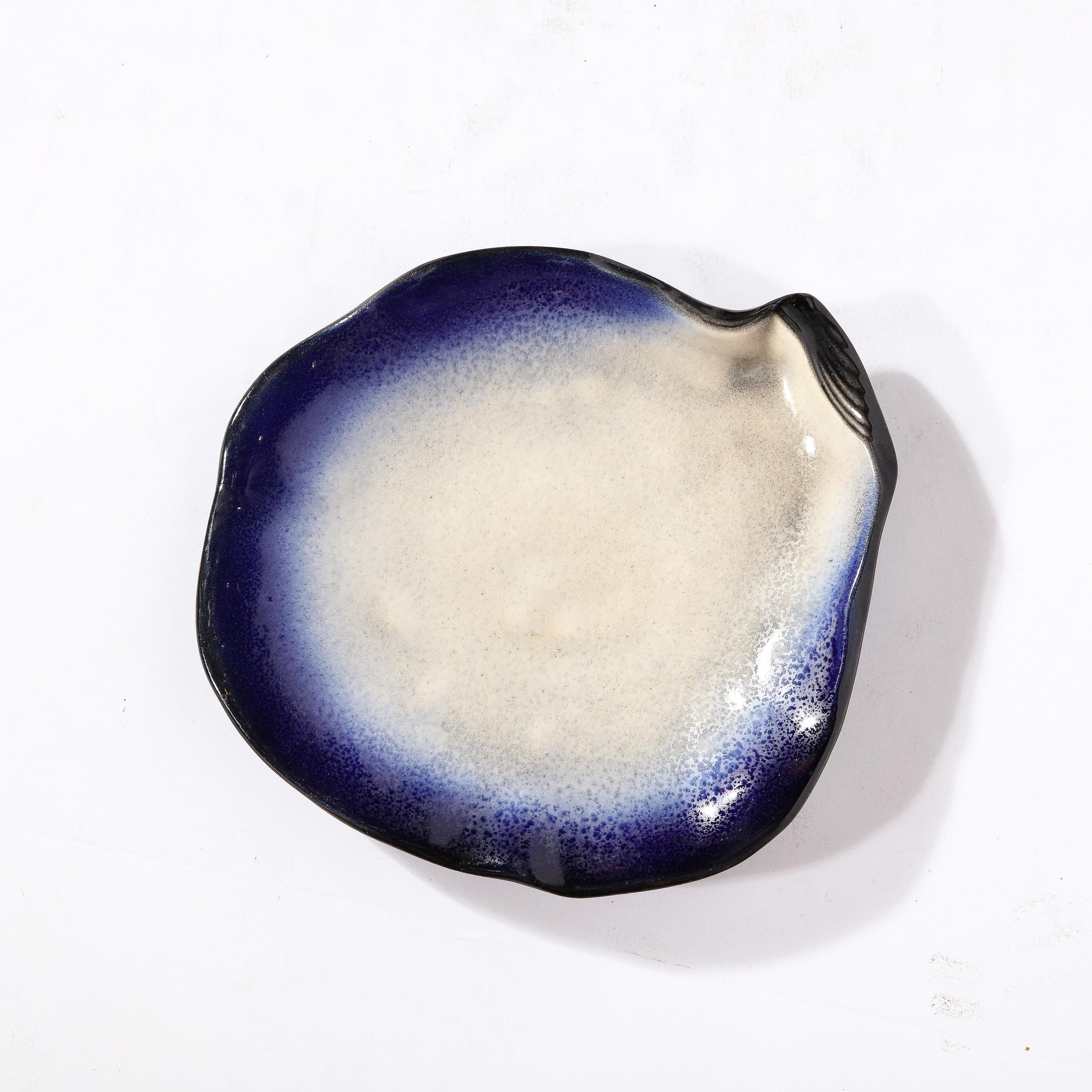 This lovely Oyster form Ceramic Plate signed Pol Chambost originates from France, Circa 1960. Depicting an abstracted Oyster with undulating natural curves around the edge of the piece, the surface has a gradient of deep ultramarine blue blending