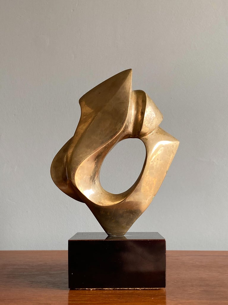 An abstract cast bronze sculpture with beautiful movement. Signed “1982 Conley 3/20.” Nice untouched original condition. A lovely sculpture and would be a compliment to any surface area.