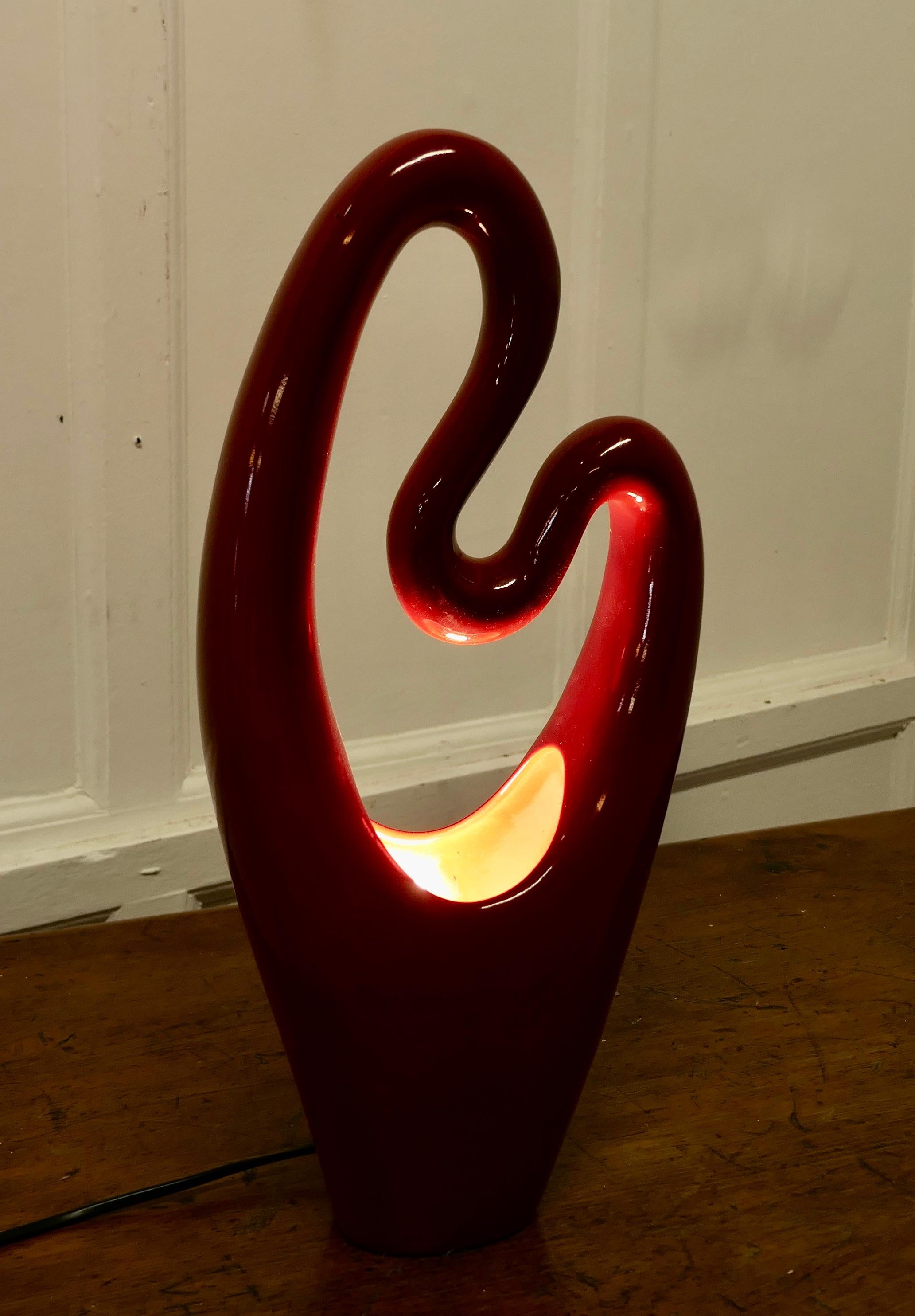 Mid Century Abstract Ceramic Lamp in Cerise

An unusual shape with the light bulb concealed in the bottom of the lamp, this makes unusual and attractive patterns when lit
The lamp is 18” tall, 8” wide ands 4” deep
MS269