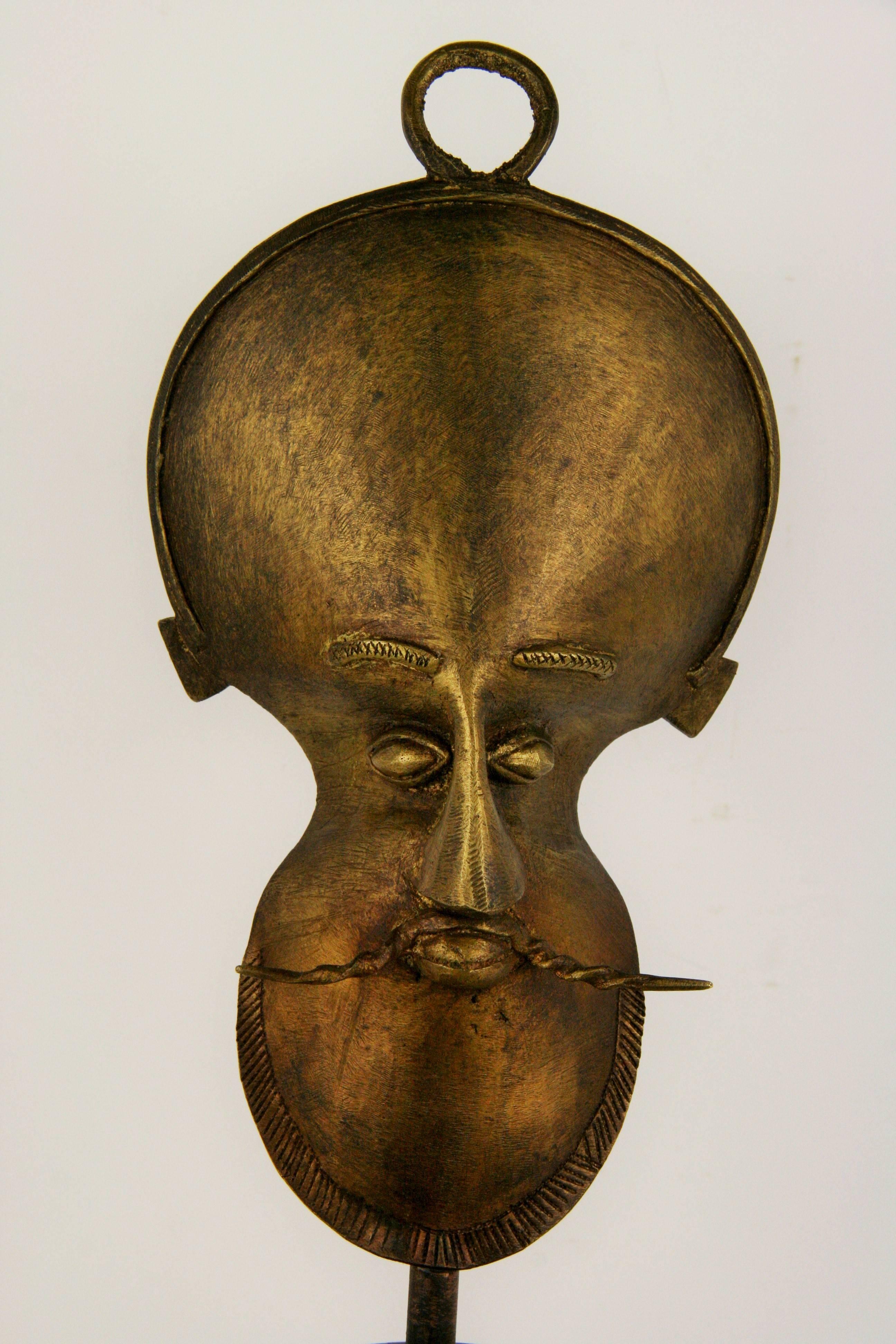 Mid-Century Modern brass sculpture figure on a solid mahogany base.
No makers marks.