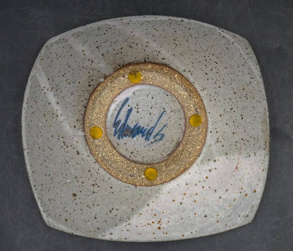 Mid Century studio shallow pottery bowl by well known California potter Joel Edwards. Rounded square shallow bowl shape, speckled cream with gray and olive abstract design, signed on bottom.