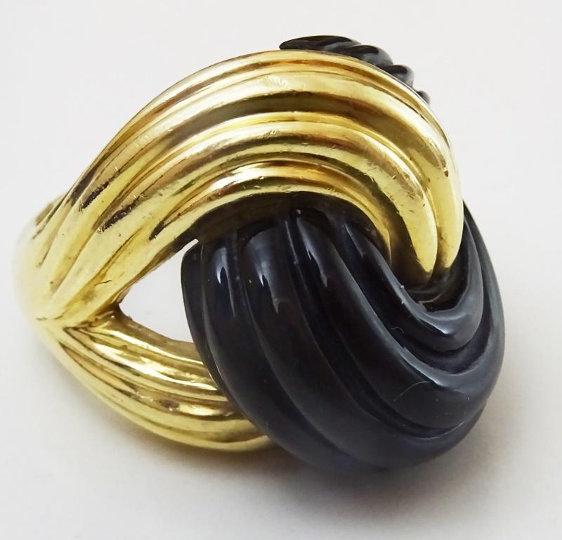 This Ring is typical of abstract designs made in the 1960's.
Made in fully marked 14 karat Gold.
A Uniquely carved Onyx aligns perfectly with the design on the gold, giving the whole piece a flowing feel.
The Ring is size 8 American - 17 European.
