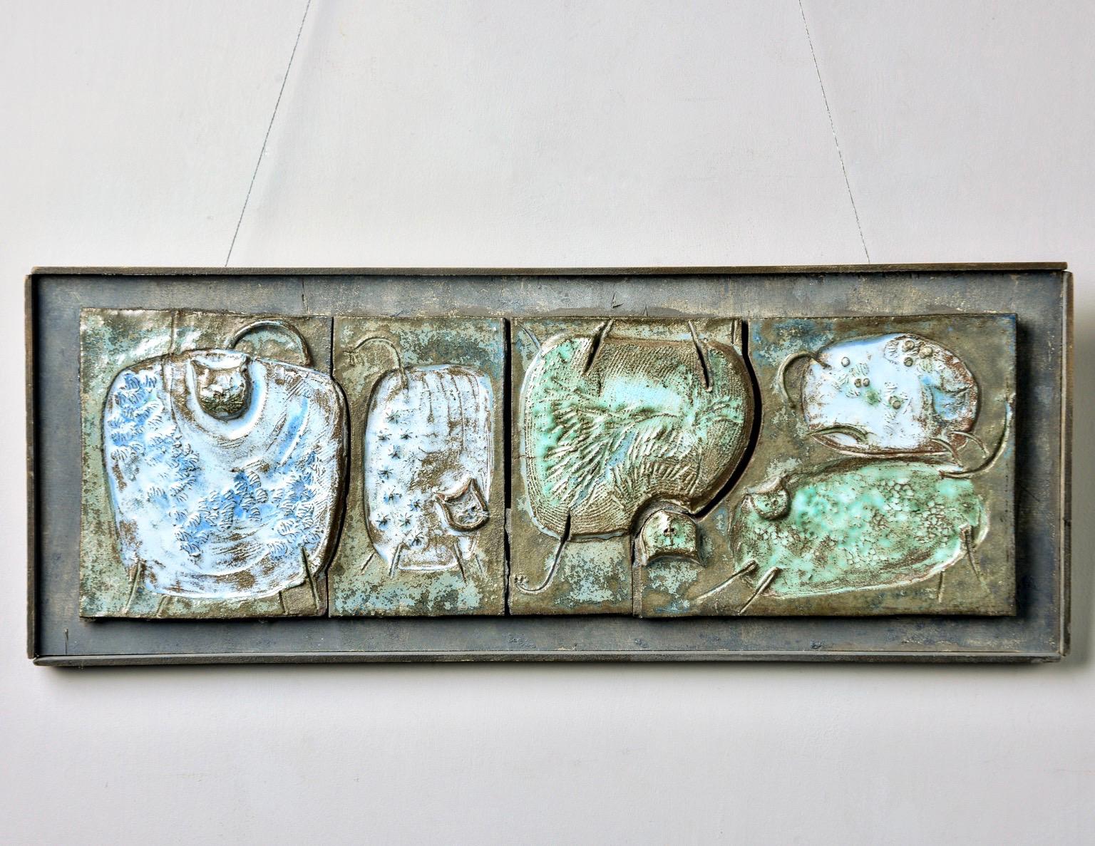 Found in Belgium, this circa 1960s ceramic plaque is glazed in tones of green and blue and mounted upon a dark gray painted wooden frame . The ceramic plaque features four etched abstract cats with some elements rendered in relief. Unsigned -