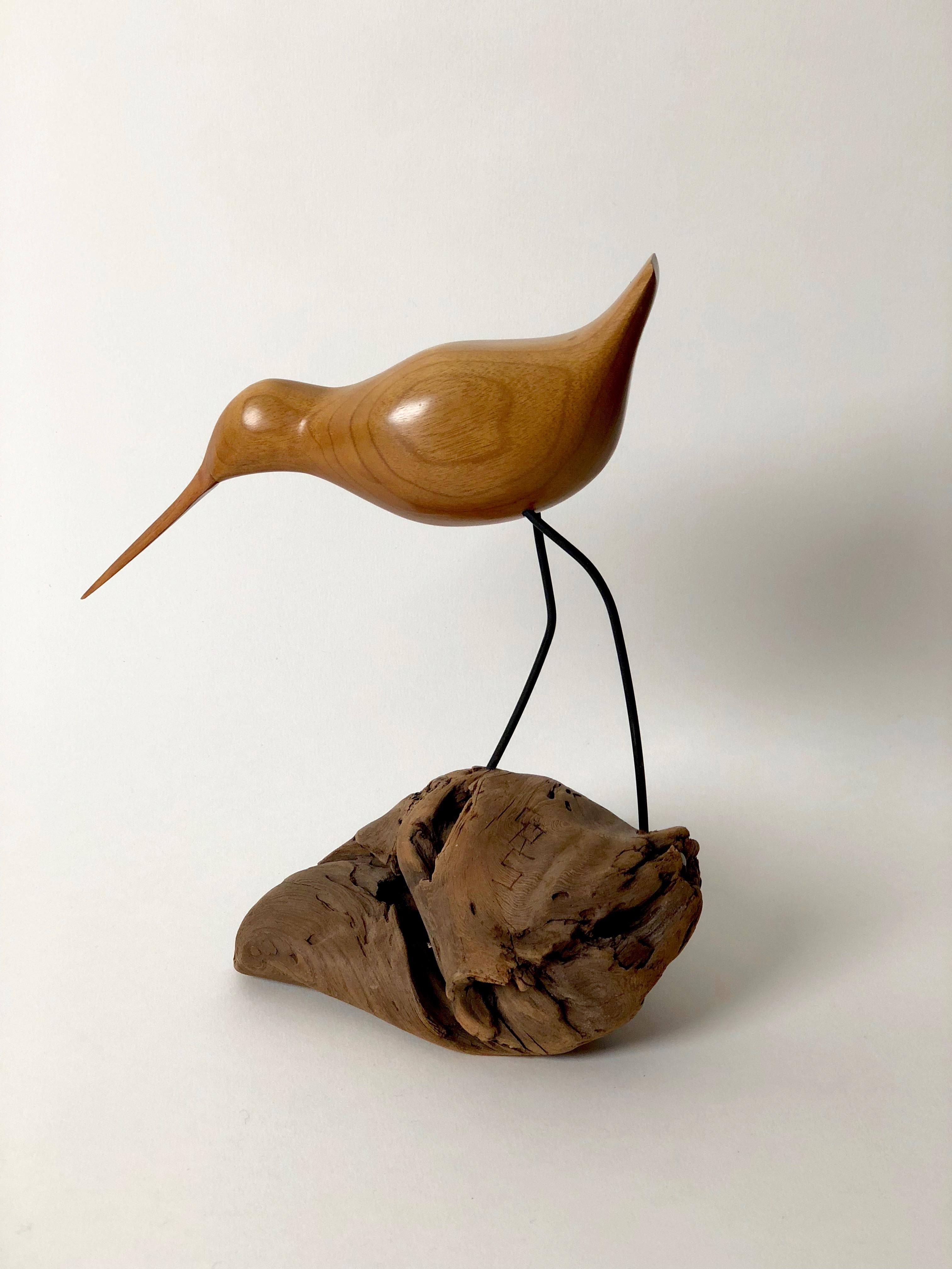 This hand carved sculpture, of a bird, was made by an unknown Artist in the 1950s. The articulation of the form comes from careful observation 
resulting in a beautifully balanced object mounted on a piece of drift wood. The work is signed with the