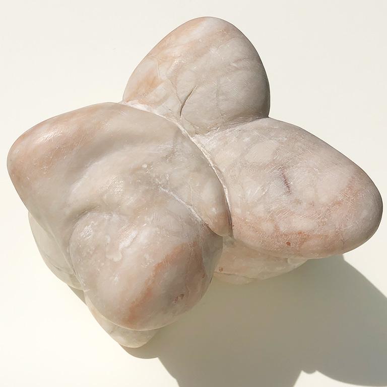 Mid-Century Modern abstract solid marble sculpture with biomorphic form. Extremely heavy. Unsigned, and likely mid-20th century. Marble has a soft matte honed finish and varies in color from white and ivory to pale pinks with beautiful veining. It