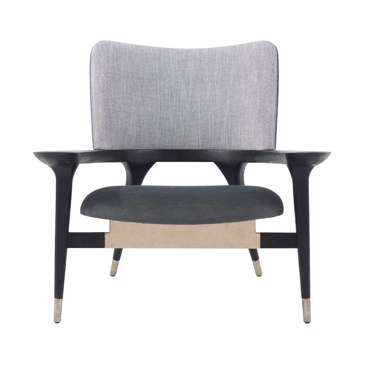 With dark charcoal finish on the comfortable curved barrel backrest. Upholstered cushions with brass details.

An improvement on the stylish Mod design with shapely legs that taper beneath the elegant frame and a floating seat. Gracefully curving