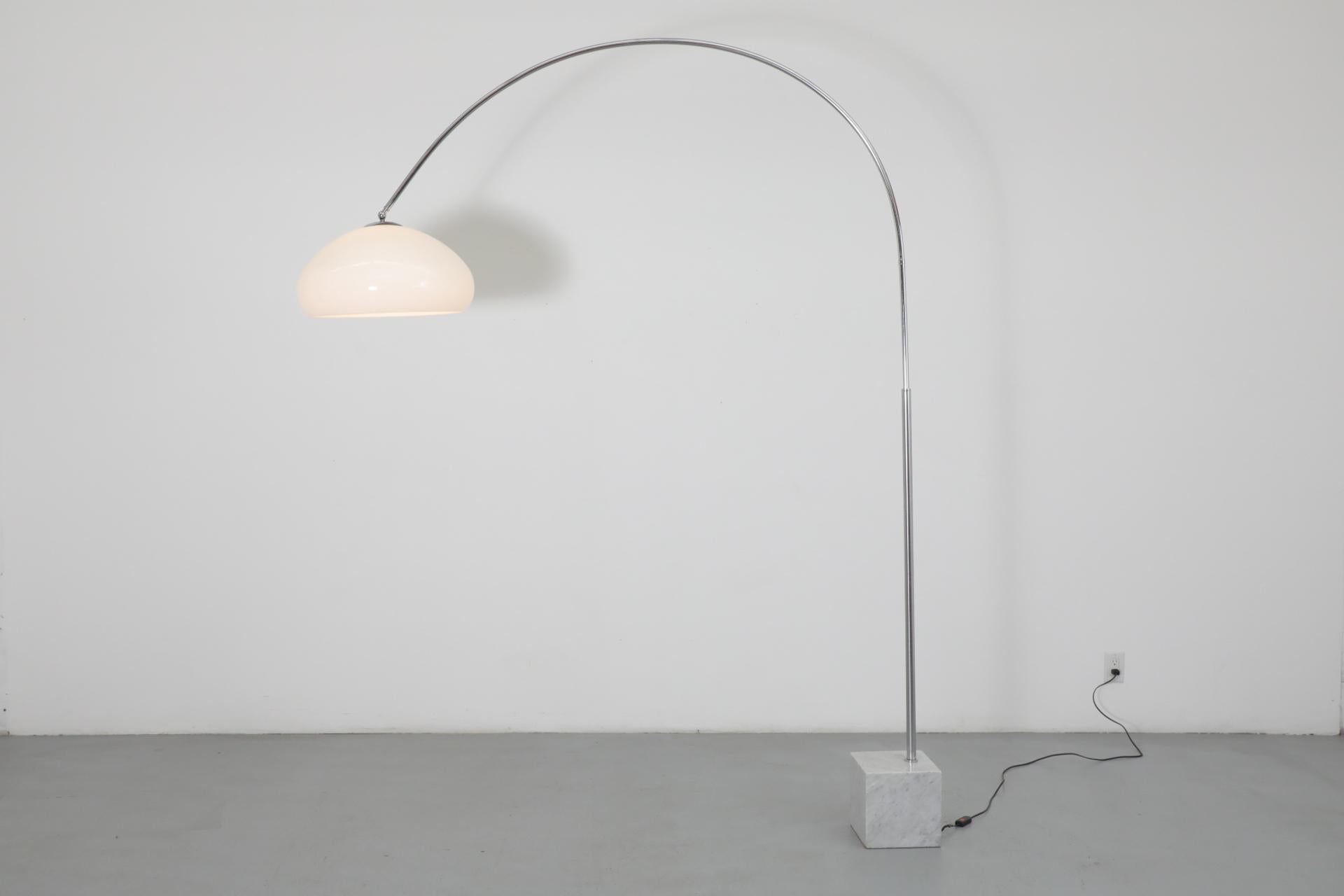 Mid-Century Castiglioni inspired standing arc lamp with marble cube base, arcing chrome stem and white acrylic shade. Stem swivels at mid-section on stem but does not adjust up and down. shade adjusts at ball joint. In original condition with
