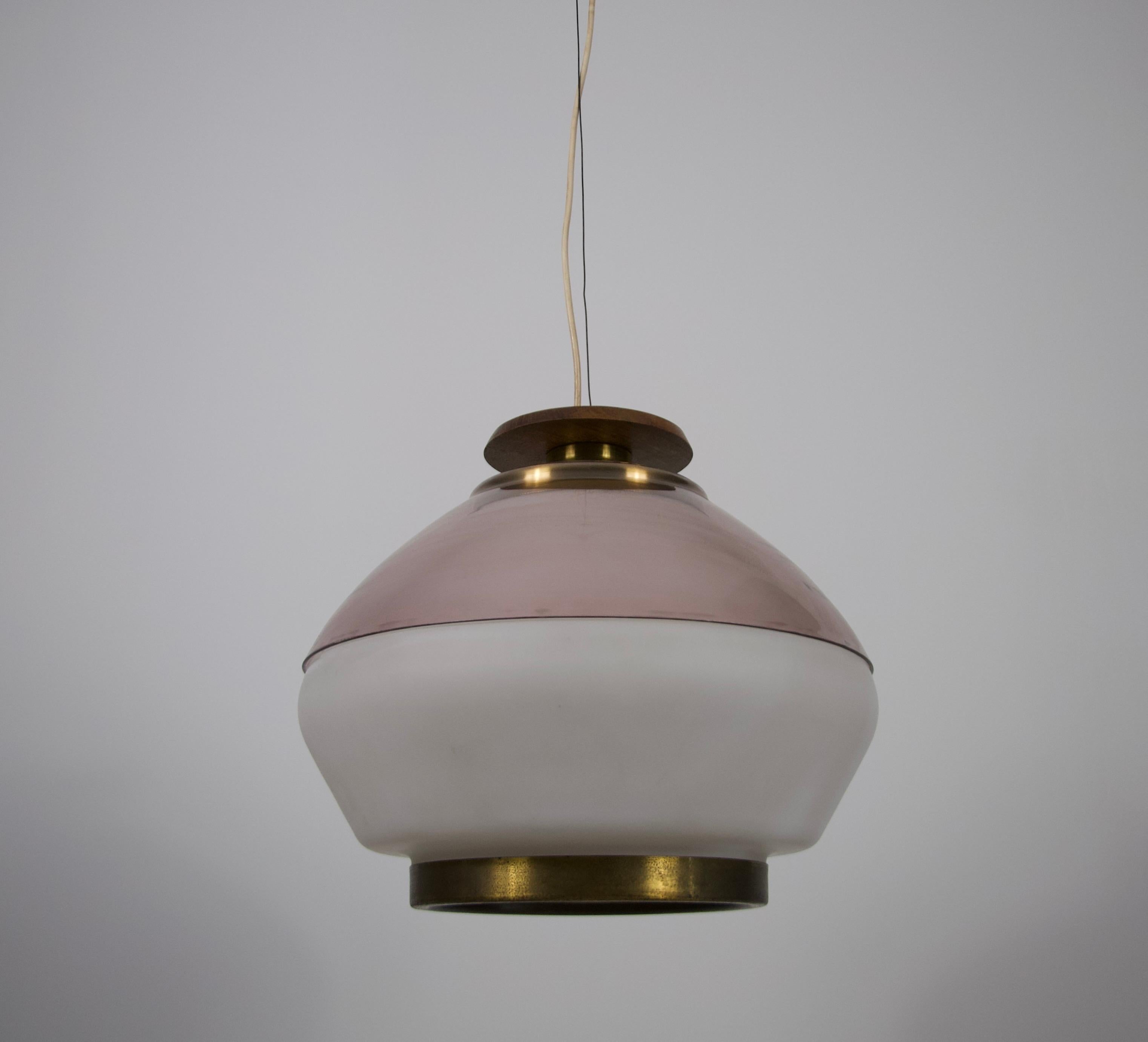 This elegant Italian ceiling lamp by Stilnovo from the 1960s is a stunning example of mid-century modern design. The centerpiece is a beautifully crafted opaline glass shade, further enhanced by a refined acrylic glass element that adds an extra